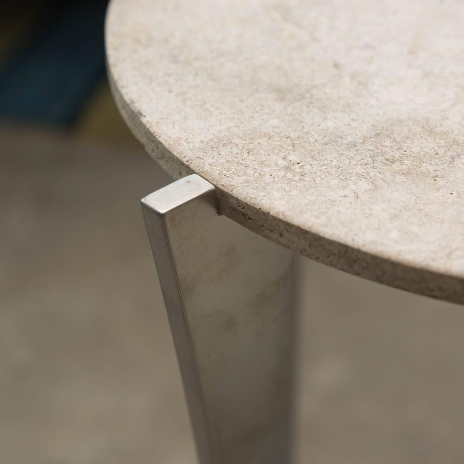 A set of sculptural drink tables made from heavy 1/2 inch solid steel with inset travertine tops by Gregory Clark.