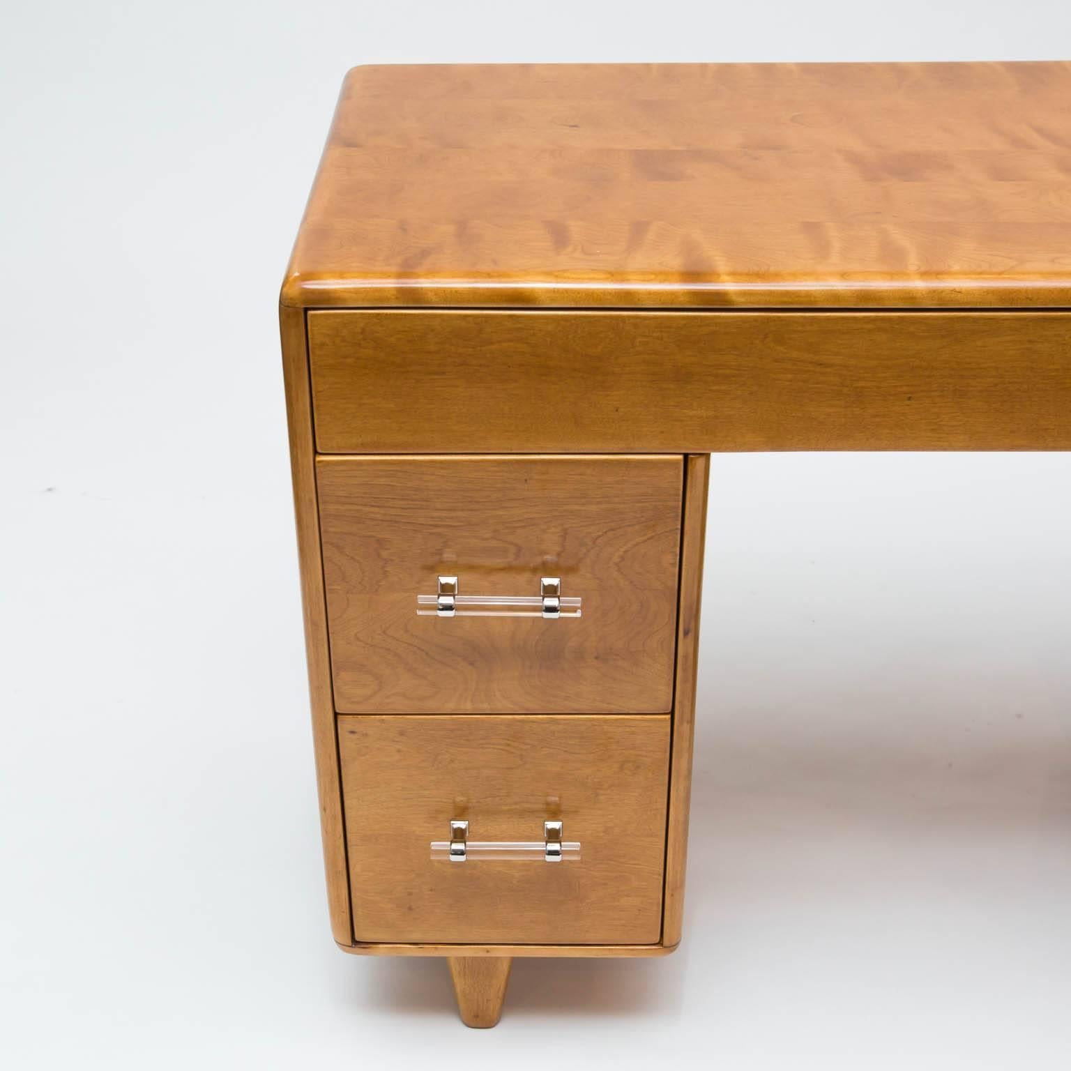 Vintage maple desk just refinished in a clear lacquer with Lucite and nickel handles.