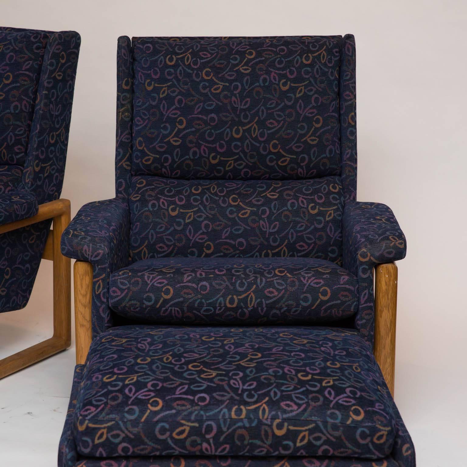 Great lounge chairs from the 1980s with a Danish modern influence. Made of a clear stained oak frame and upholstered in contemporary fabric with a navy blue background. Two are available. Price listed is per item.