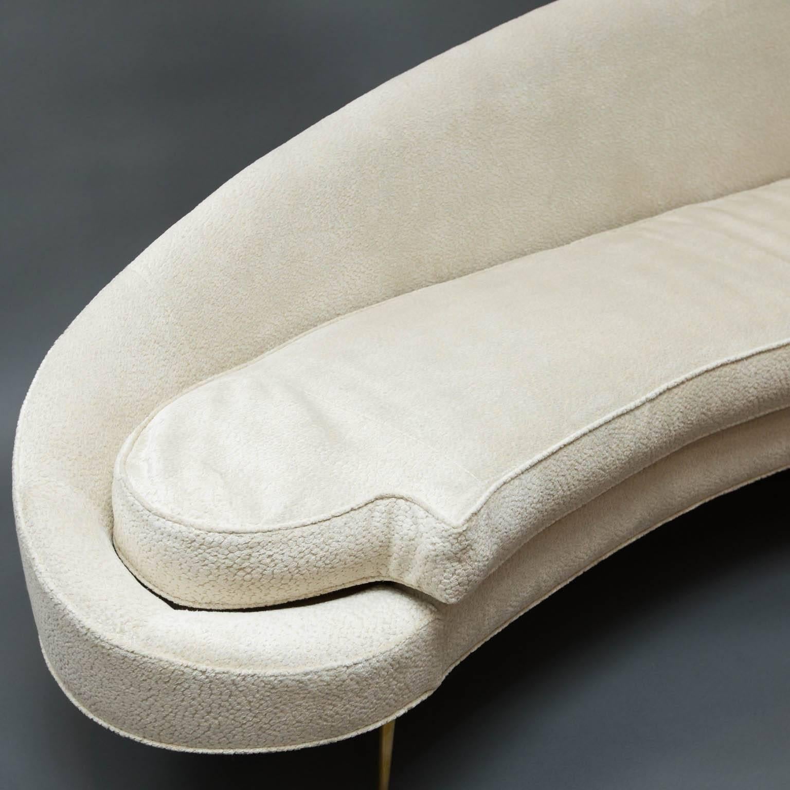 Dramatic sofa covered in Lee Jofa tone-on-tone textured velvet with fllaired brass legs.