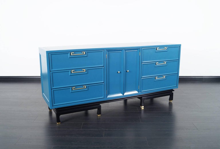 Vintage lacquered dresser by American of Martinsville. Newly refinished in a laguna blue finish with a black base. The handles are made of brass.