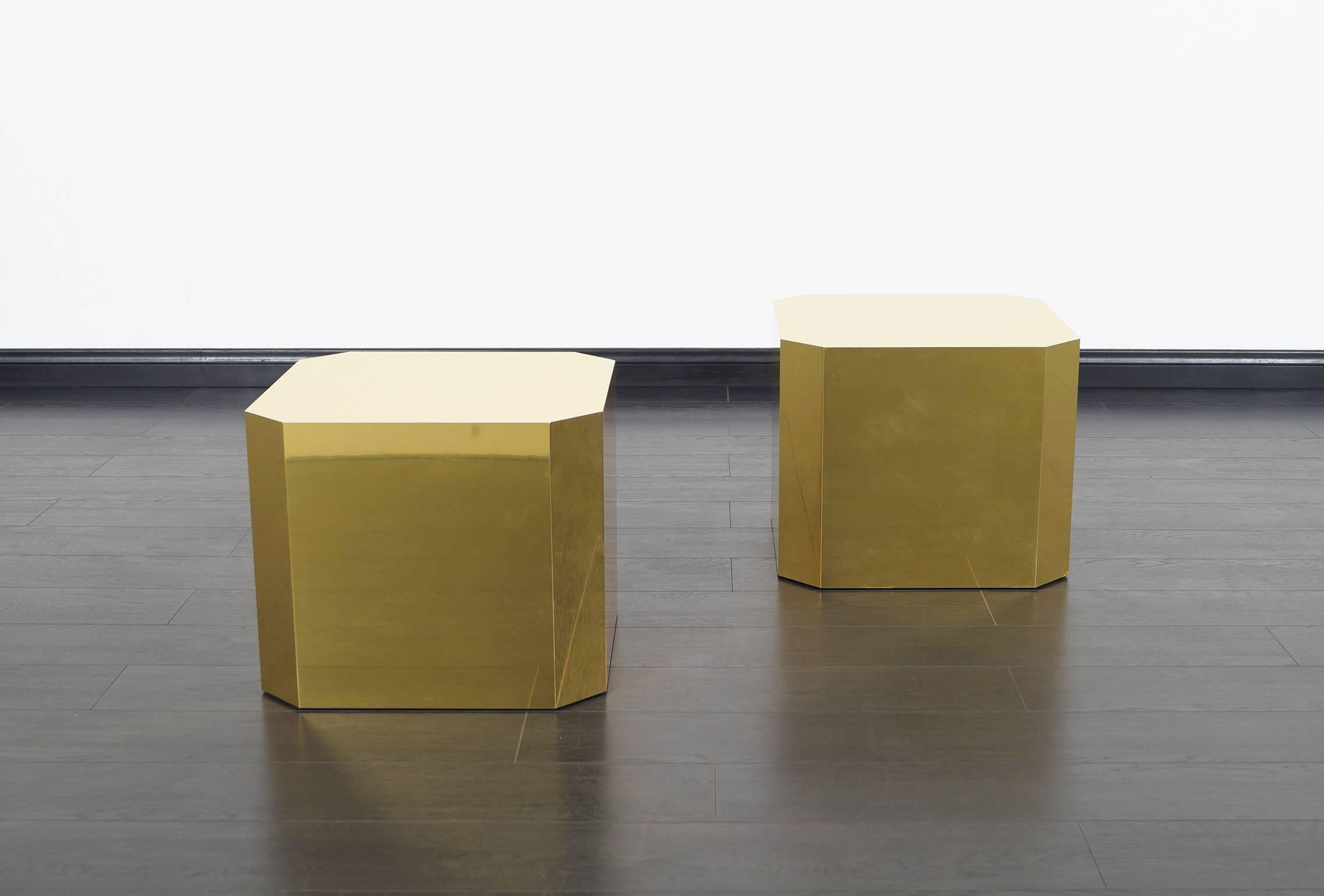 This simple yet stylish brass side tables were manufactured by Mastercraft. Can also be used as pedestals. The tables are wrapped in solid brass sheets.
