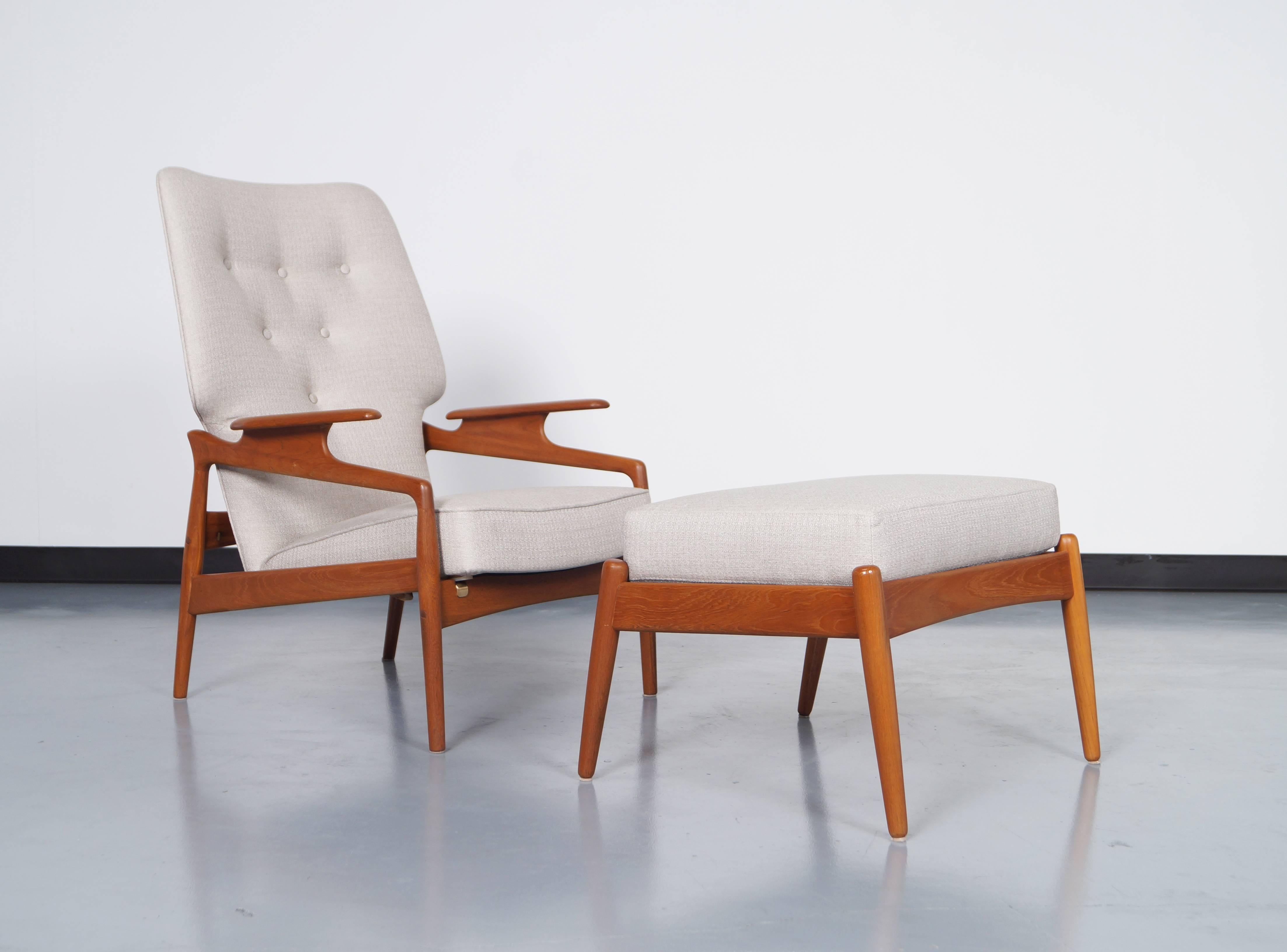 Danish teak reclining lounge chair and ottoman in the manner of Finn Juhl. Amazing sculpted armrests and newly reupholstered. The chair reclines to 45 degrees.

Dimensions for ottoman: 25.25