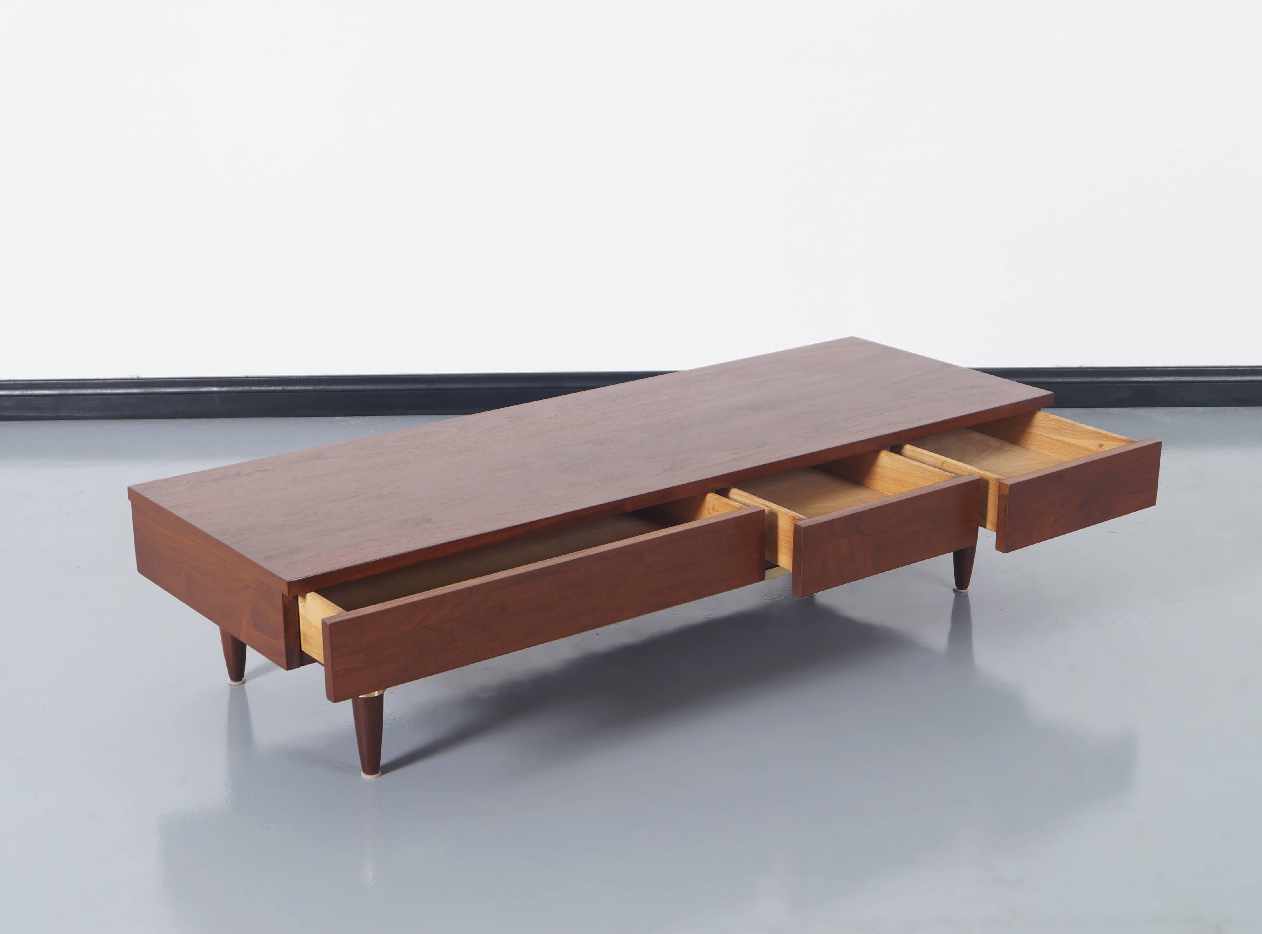 Vintage walnut and brass bench designed by Merton Gershun for American of Martinsville. Features three dovetail drawers and solid brass trim around the base. Newly refinished.