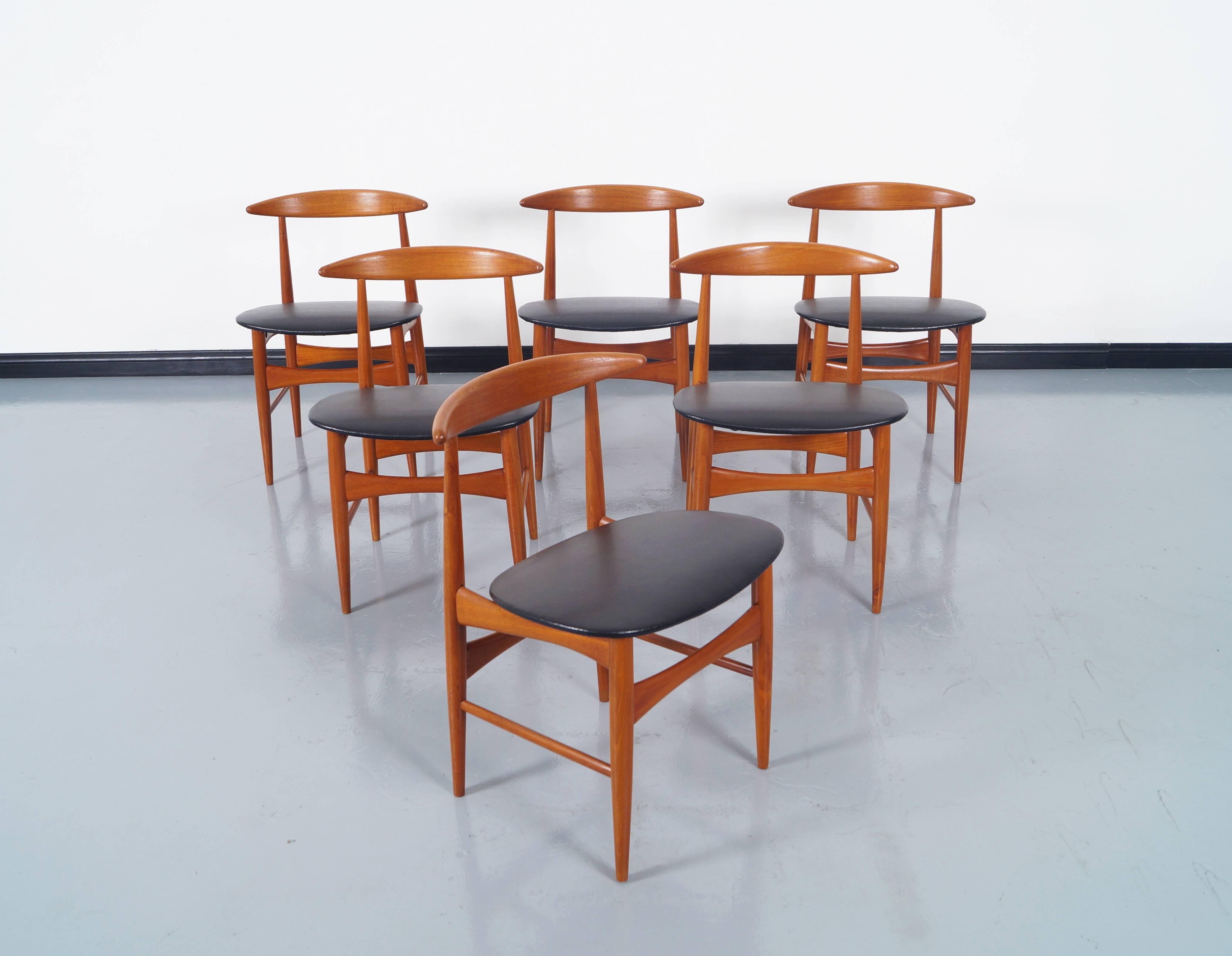 An amazing set of six Danish Modern teak dining chairs manufactured by Mogens Kold Møbelfabrik in Denmark, circa 1960s.