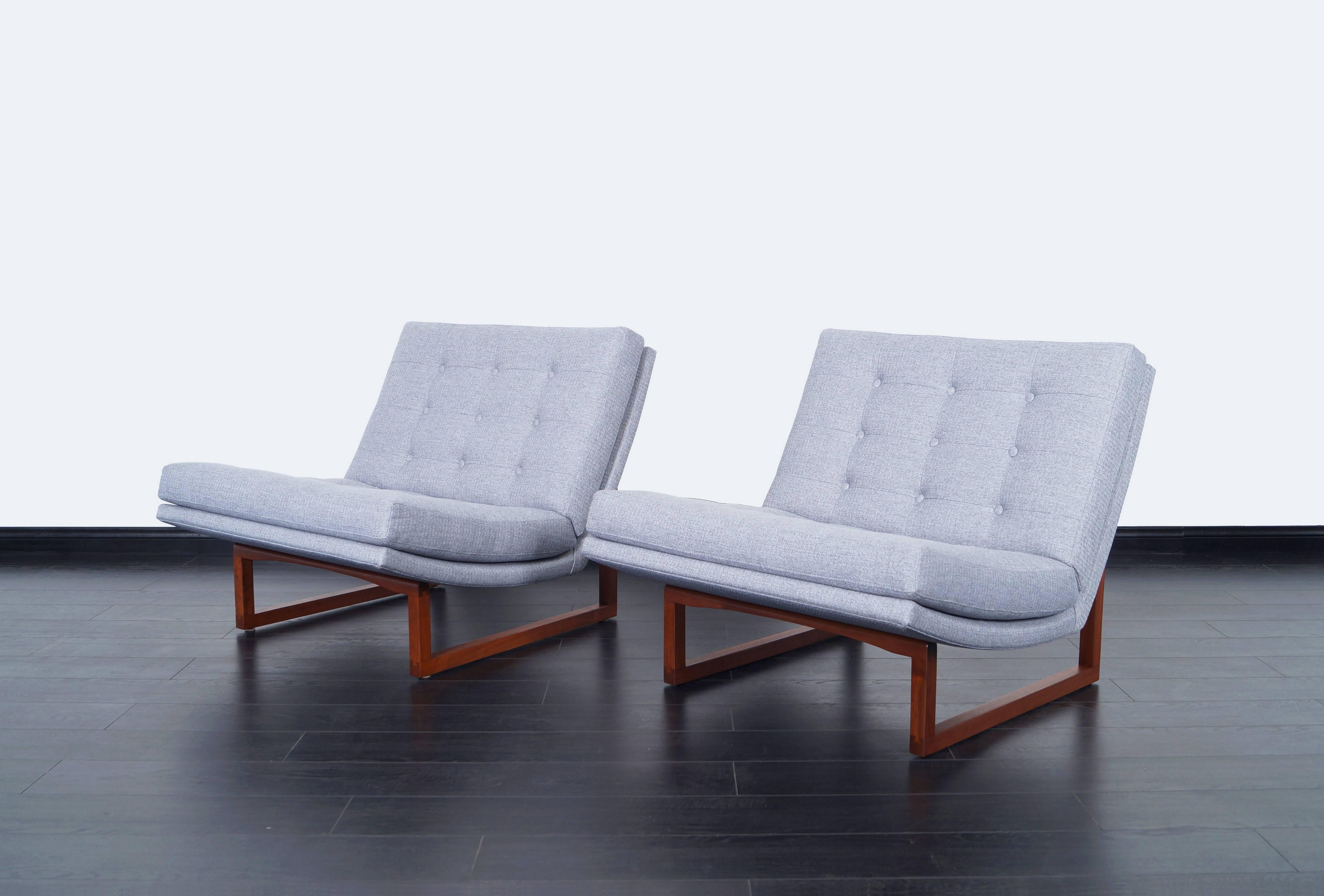 Amazing pair of tufted walnut lounge chairs by Milo Baughman, circa 1970s. Features a solid walnut frame that has been refinished with tufted seats that are newly reupholstered.