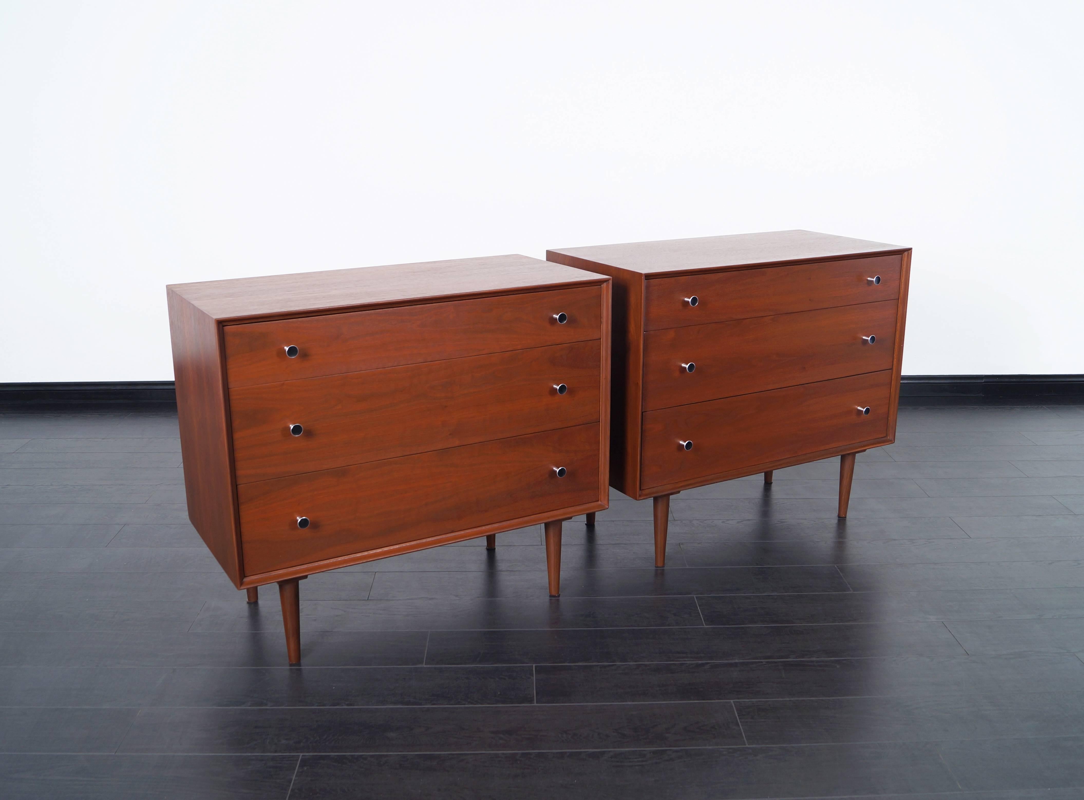A wonderful pair of vintage chest of drawers designed by Robert Baron for Glenn of California. Each chest has three drawers with original aluminum pulls.