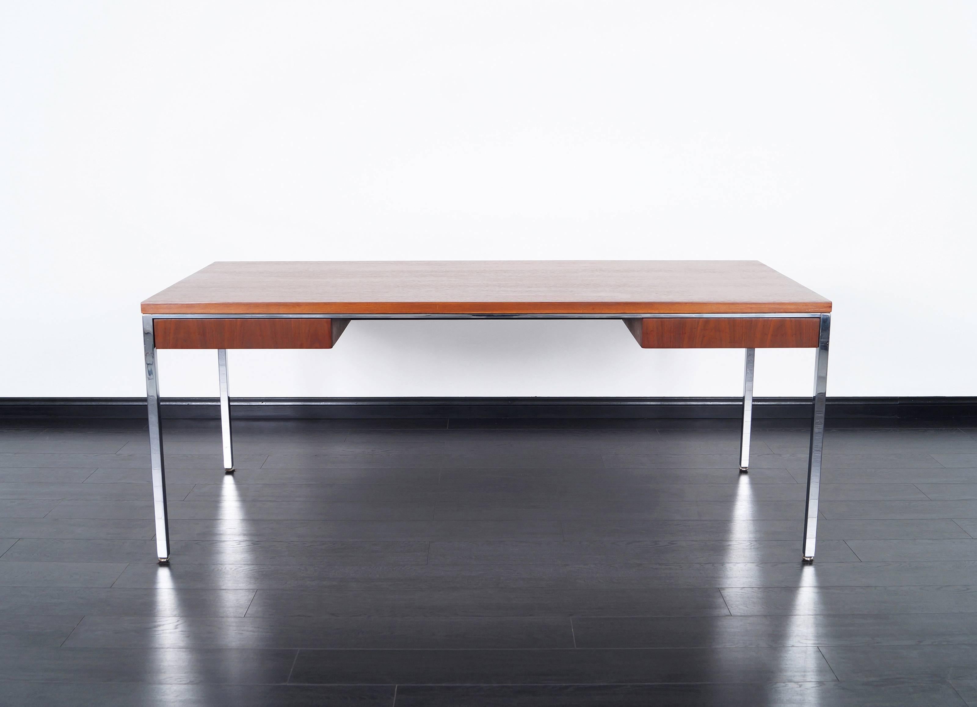 Vintage executive walnut desk by Gordon Bunshaft for Knoll. Features two pull-out drawers with chrome steel legs and wrapped around chrome on the edges.