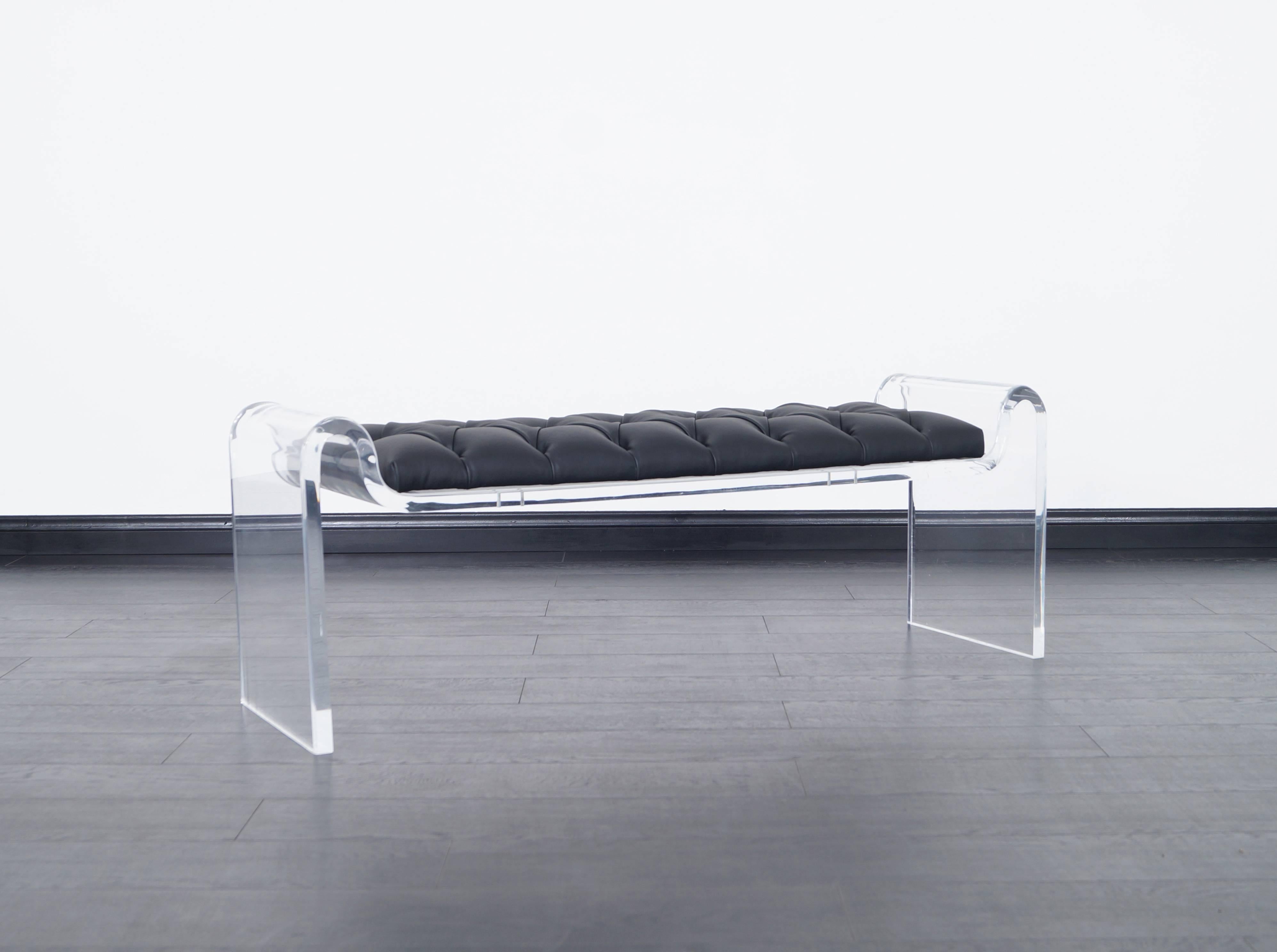 Stunning Lucite and leather bench attributed to Karl Springer. This exceptional bench exposes fabulous architectural curved legs.