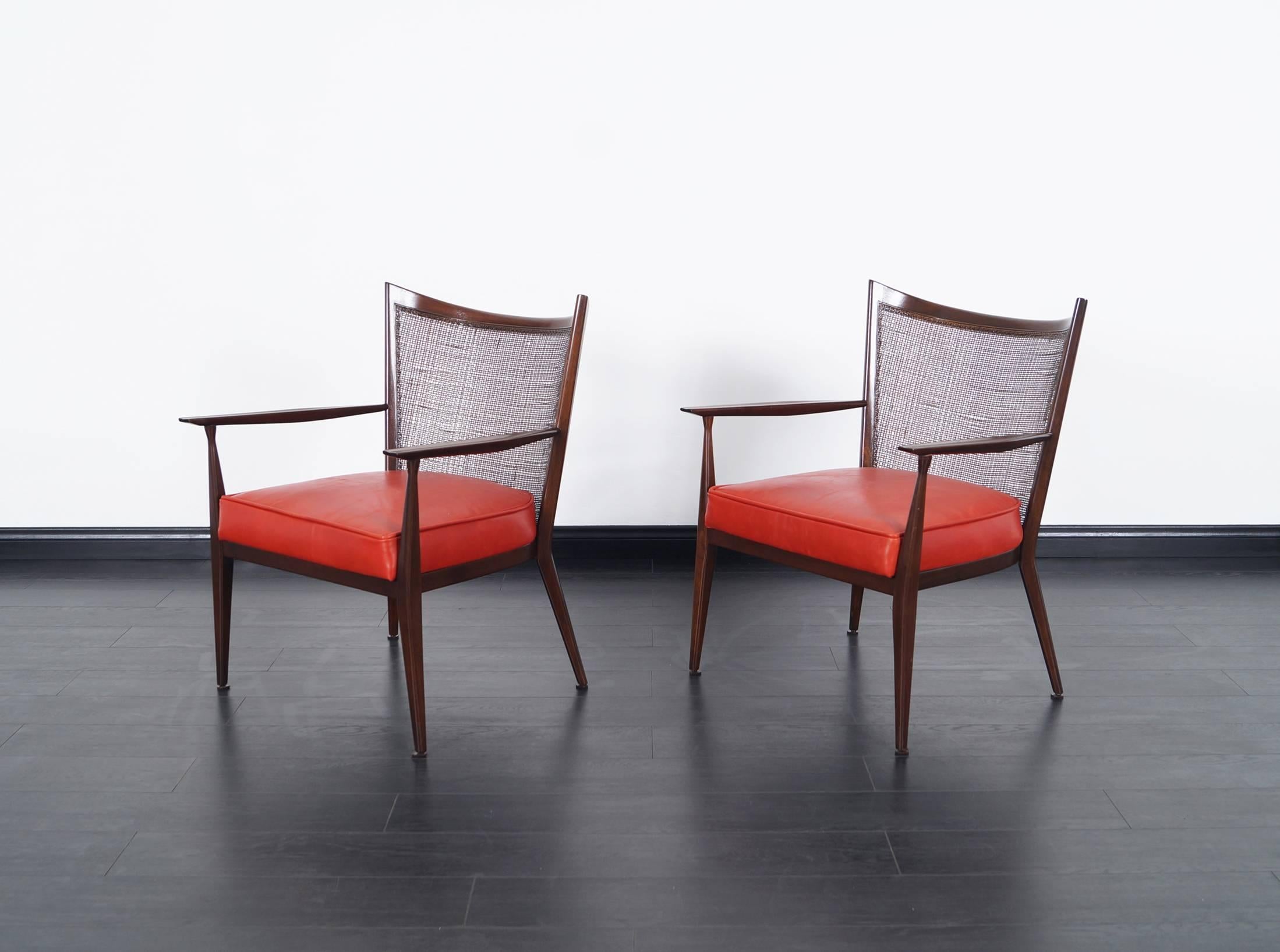 Pair of stunning lounge chairs designed by Paul McCobb for Directional. Newly reupholstered in a red-orange leather.
