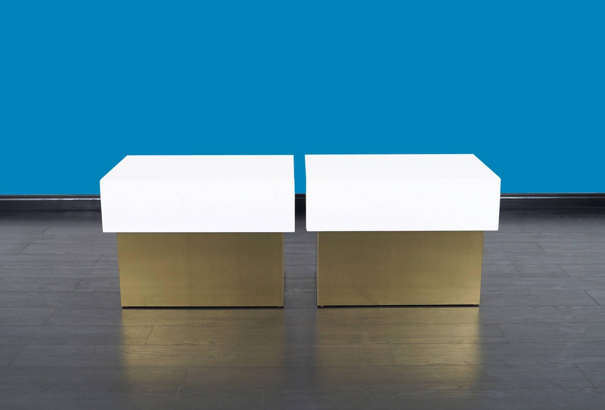 Fabulous pair of polished lacquered nightstands/ end tables, designed by Steve Chase. Each nightstands features one pull-out drawer with brass base.