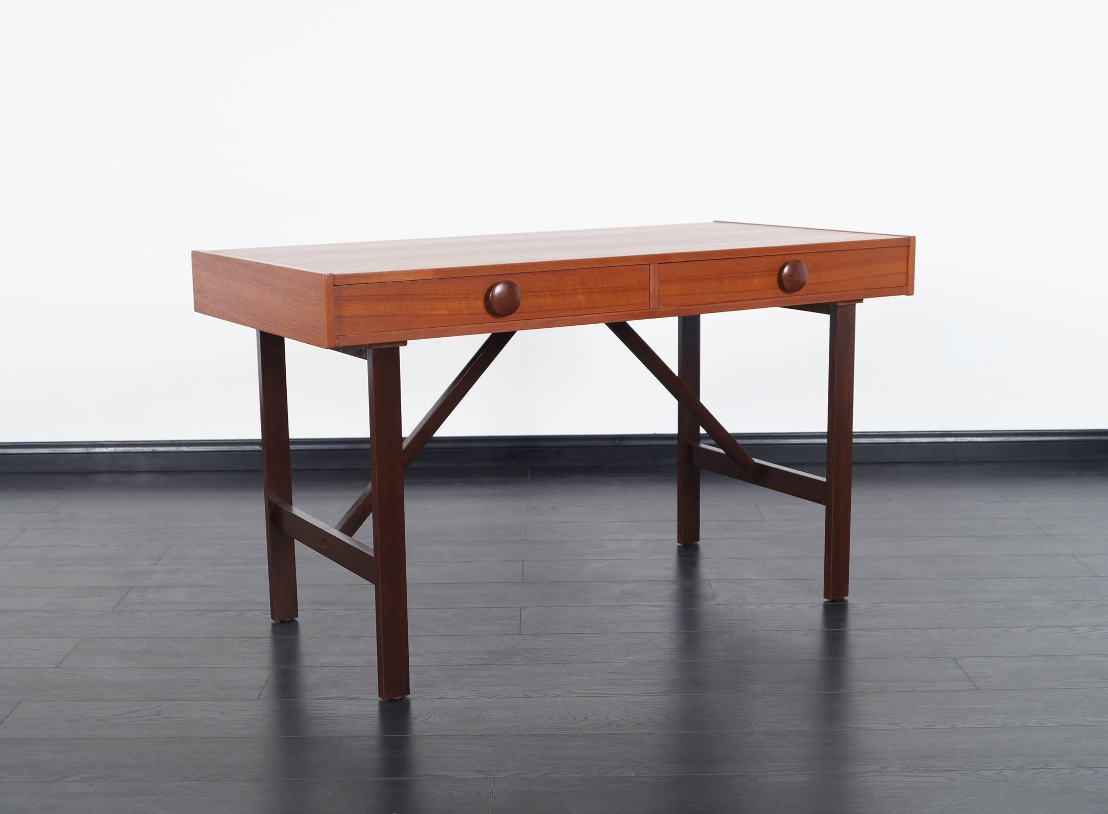 Danish modern desk features two pull-out drawers with wonderful leg design.