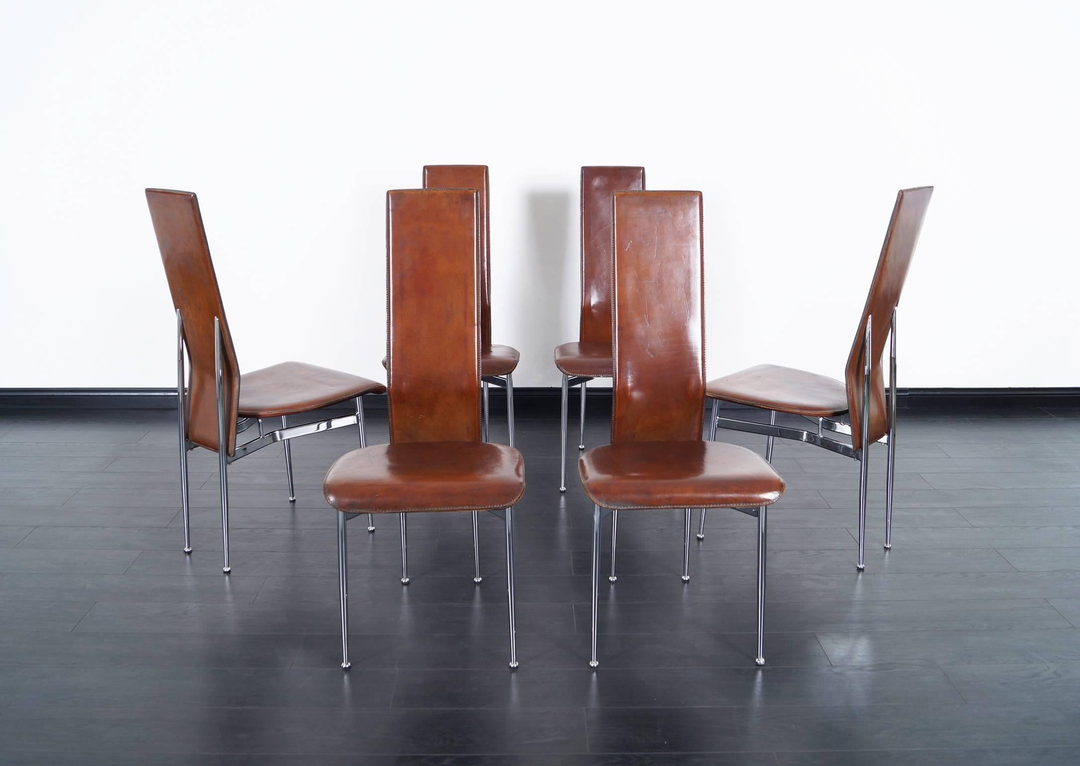 A set of six Italian chrome dining chairs with original distressed leather.