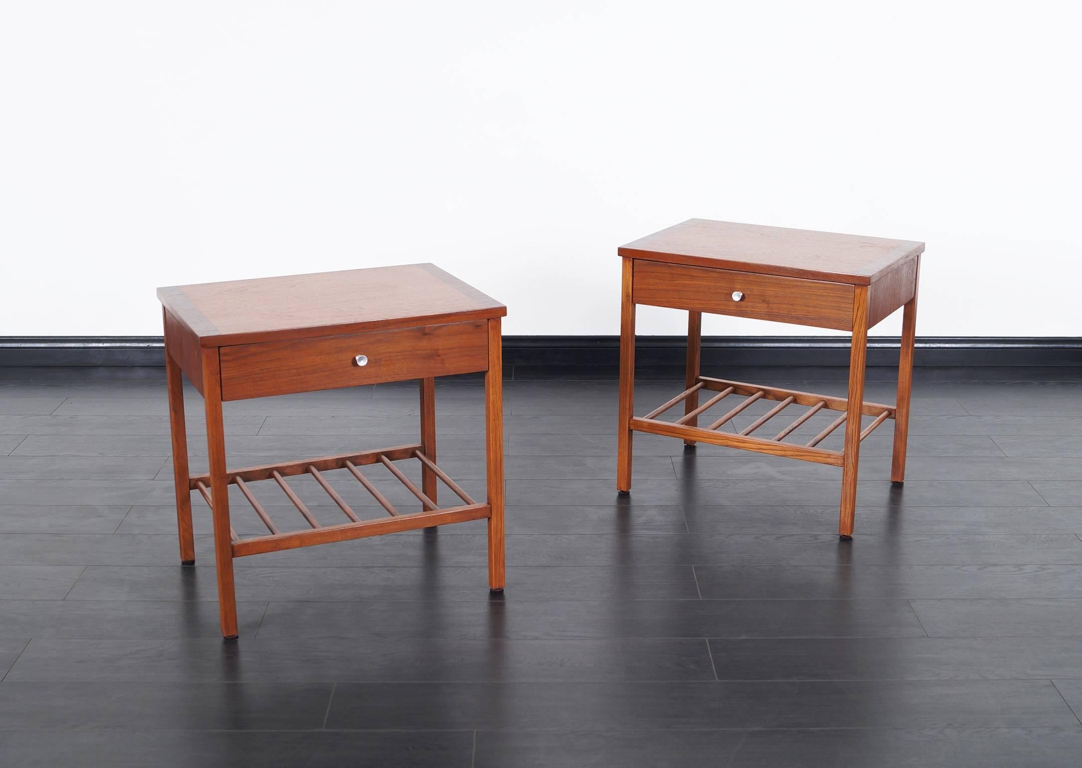 Pair of fabulous walnut and rosewood nightstands or side tables by Stanley. Each nightstand features one pull-out drawer with open storage underneath.