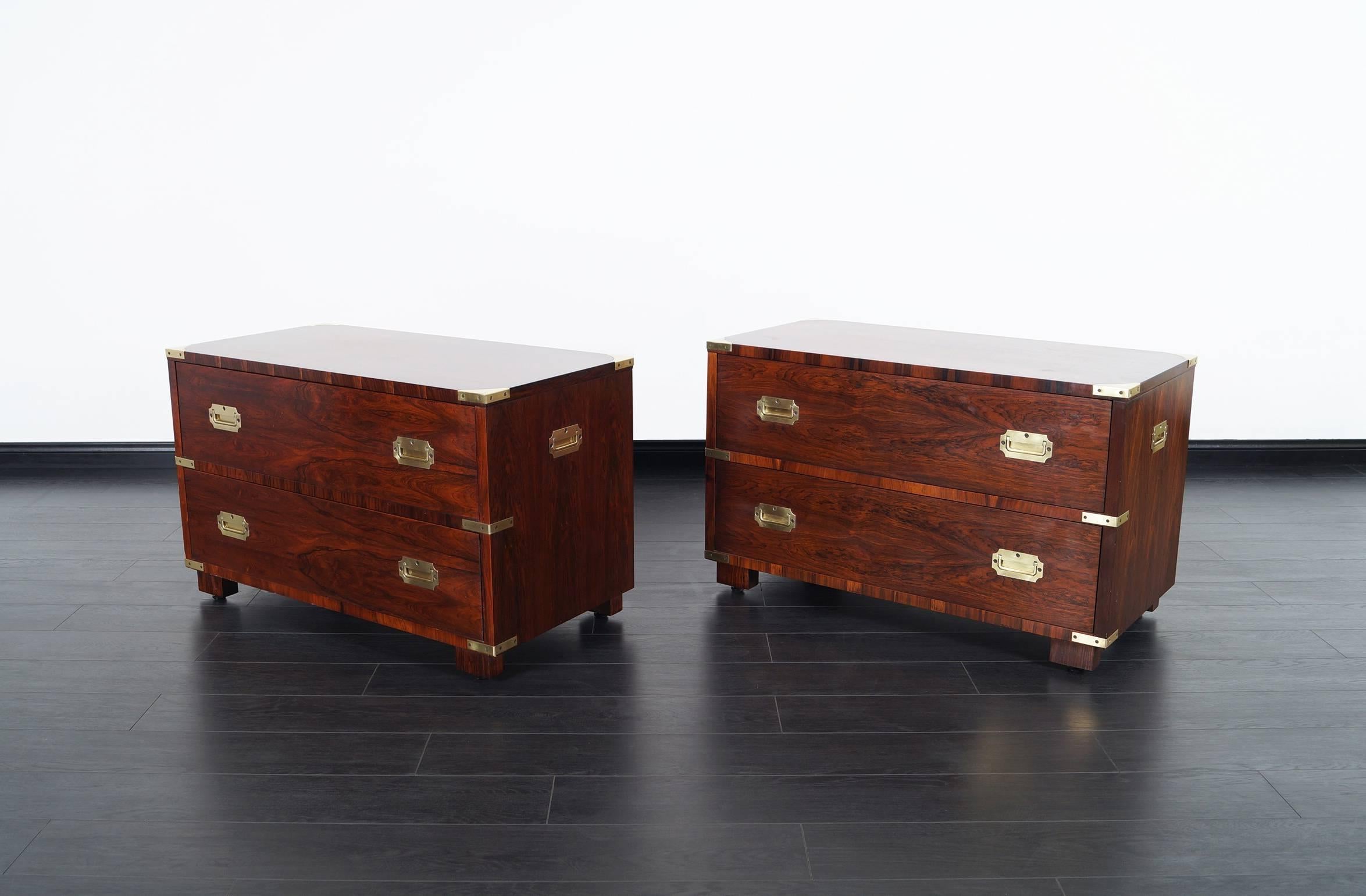 Stunning pair of vintage Brazilian rosewood Campaign style chest of drawers by John Stuart. Each chest features two drawers with solid brass hardware. This is absolutely one of the most well crafted Campaign style chests ever made, with no expense