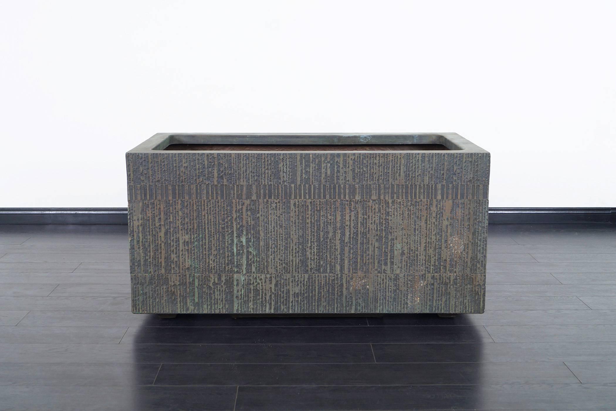 This massive cast bronze resin planter were designed by Forms and Surfaces. The interior are black fiberglass.