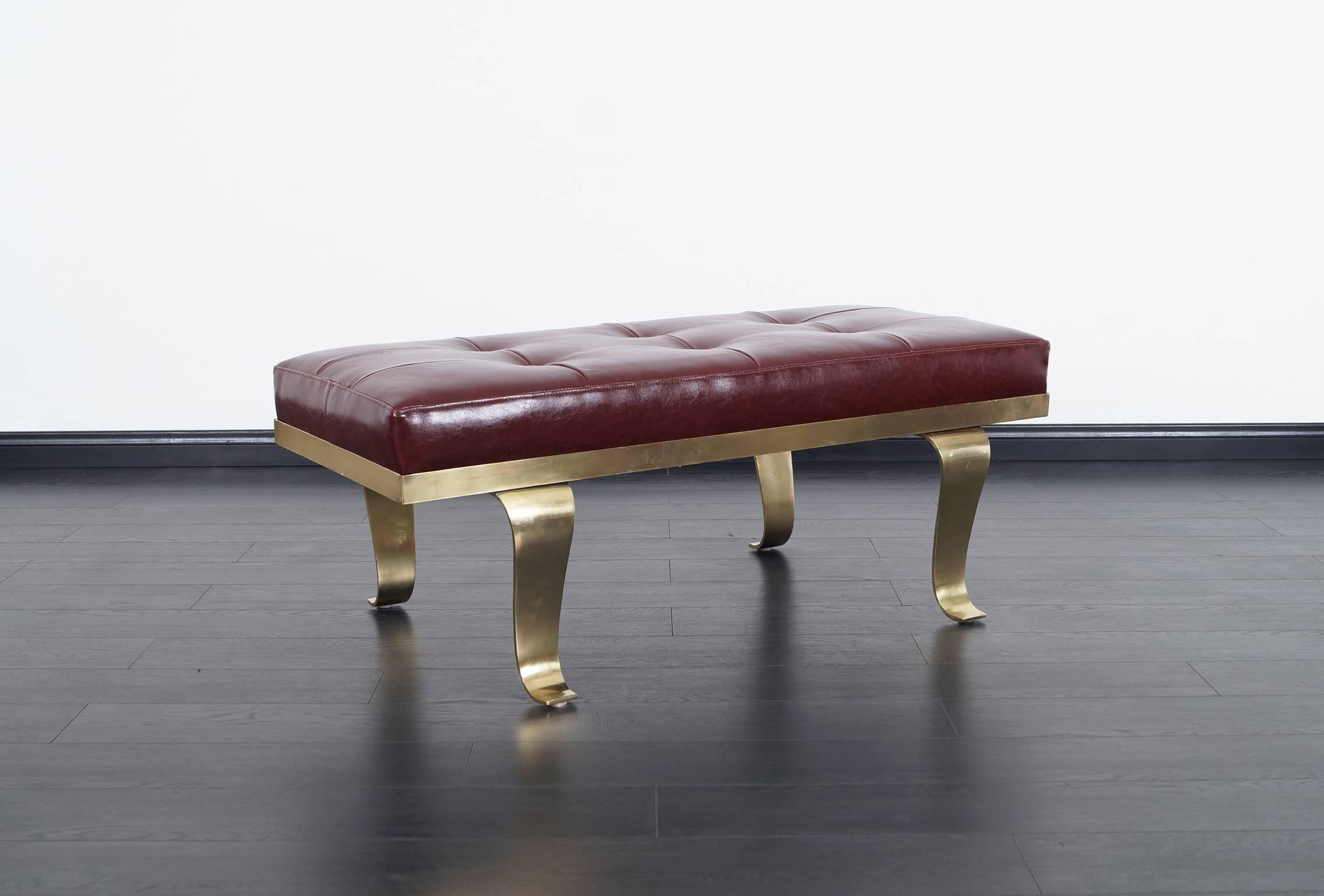 Stunning vintage brass and leather bench attributed to Arturo Pani. This exceptional bench exposes fabulous architectural curved legs.