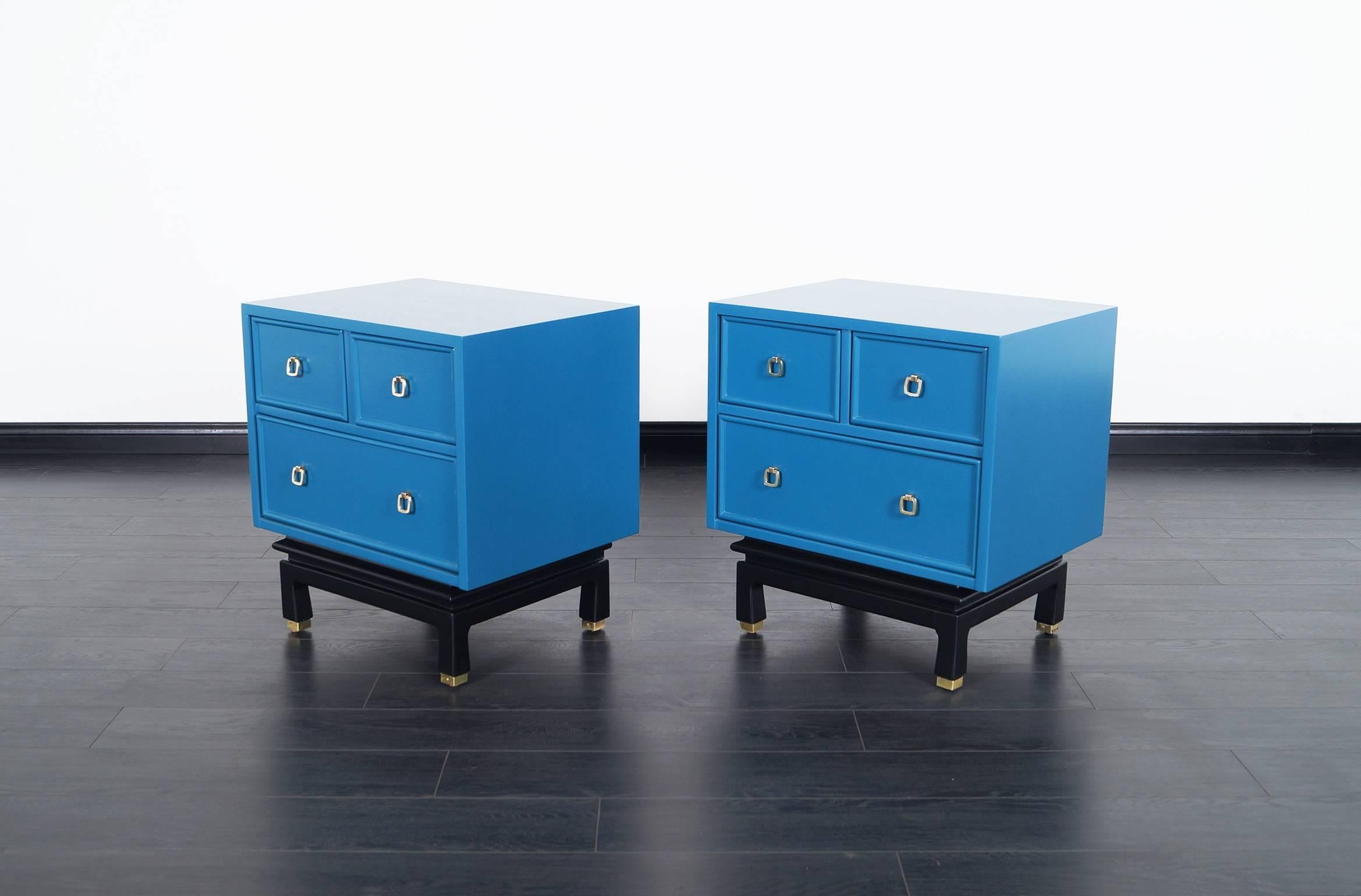 Pair of fabulous vintage lacquered nightstands by American of Martinsville. Newly refinished in a Laguna blue finish with a black base. The handles are made of brass.
 