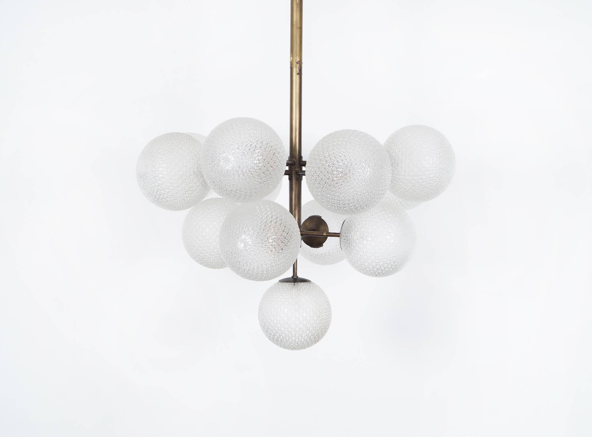 This amazing vintage glass globes chandelier features thirteen glass globes on a brass frame.