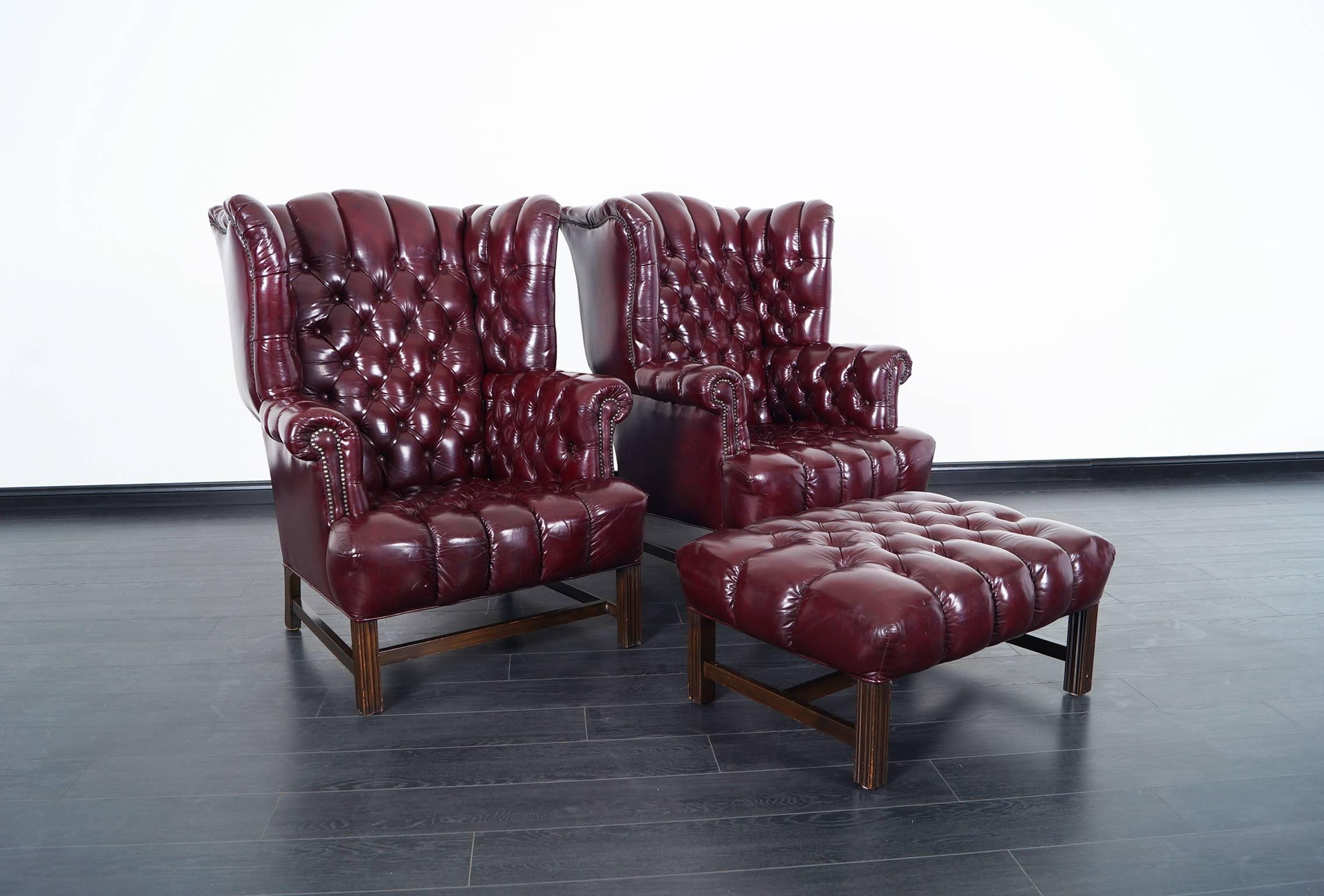 Pair of stunning burgundy leather tufted wingback chairs. Ottoman comes included. Ottoman: 32