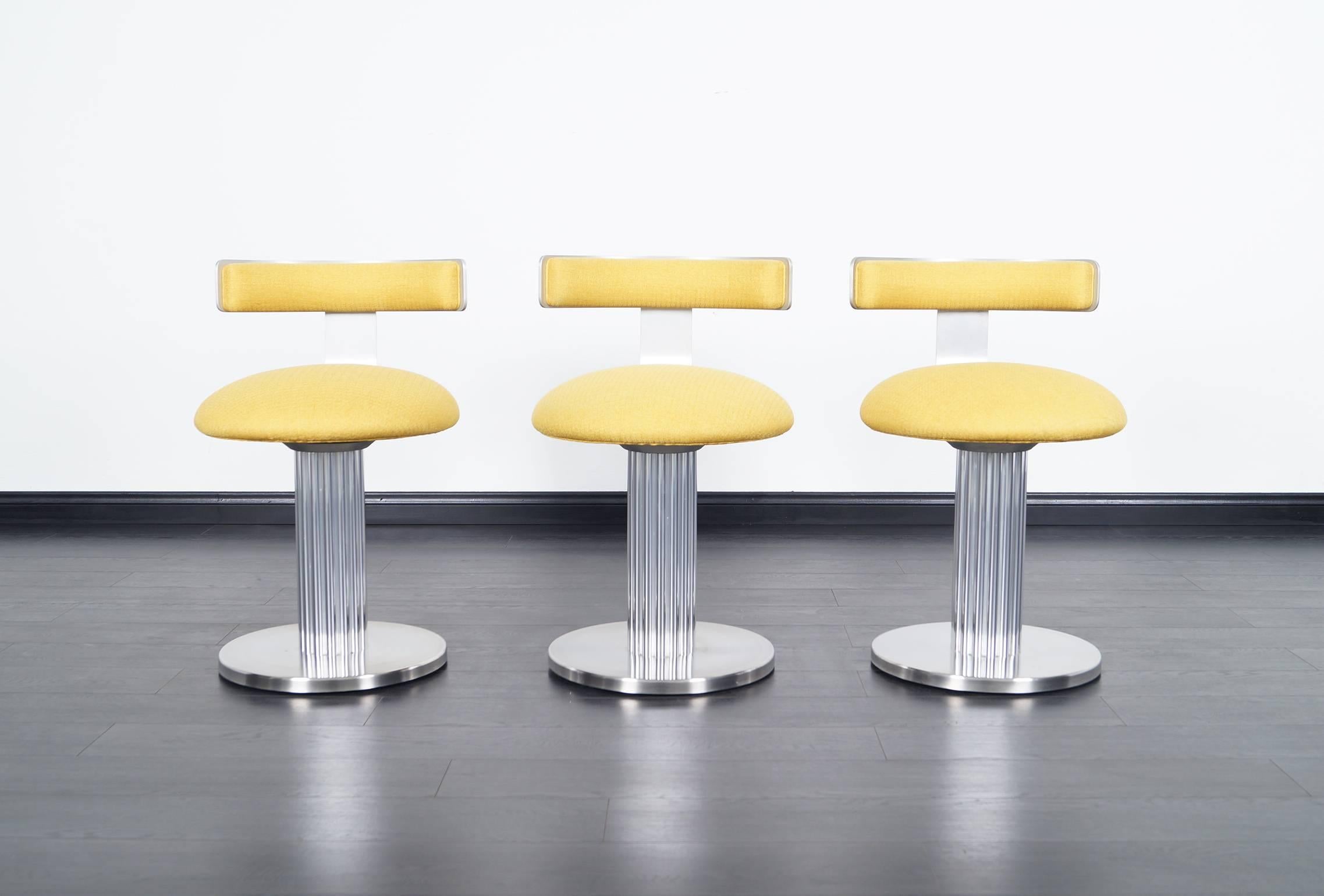 Amazing set of three chrome and brushed steel swivel stools by Design for Leisure. High quality.