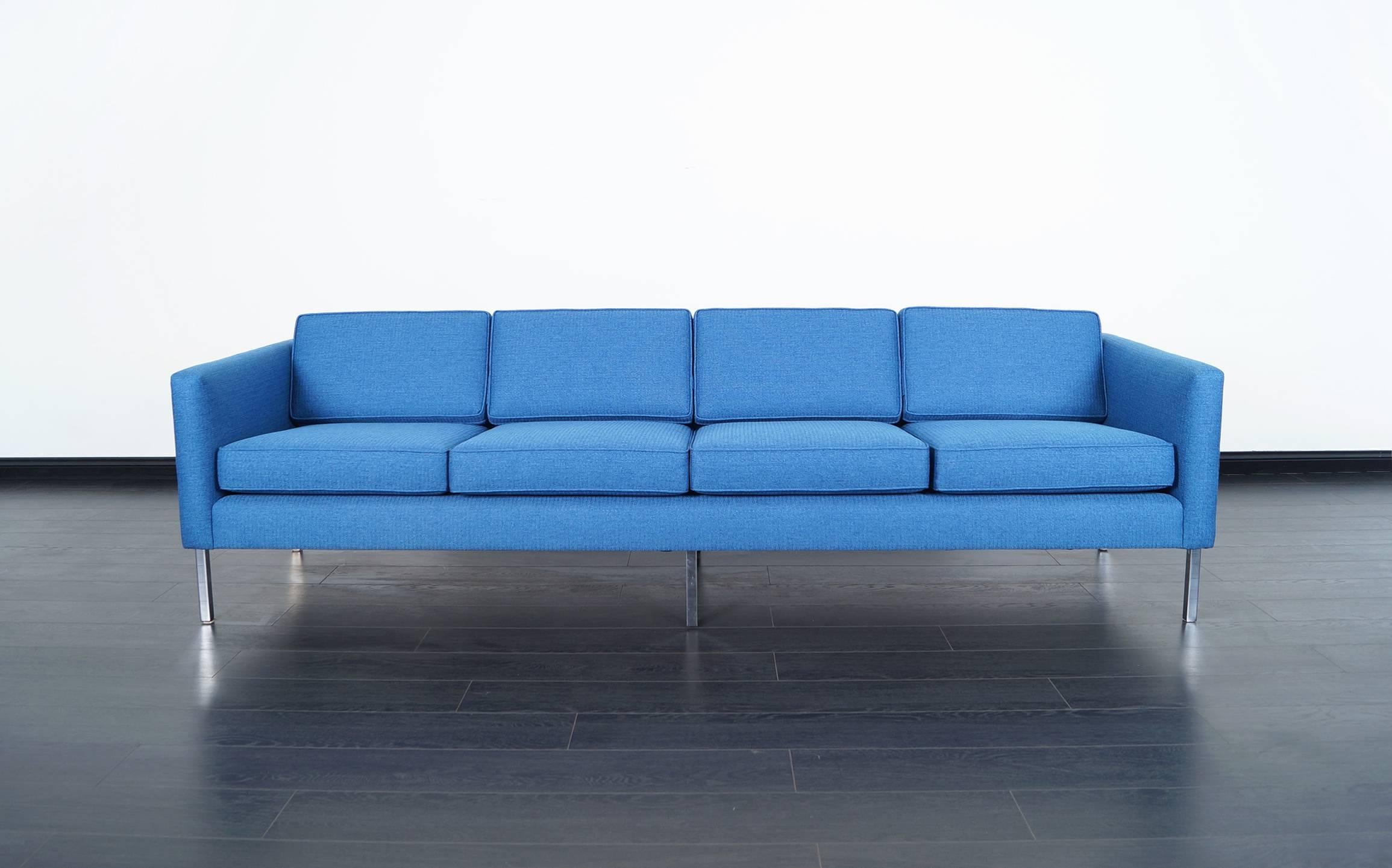 Mid-Century Modern chrome sofa in the manner of Harvey Probber, circa 1960s. Professionally reupholstered in a beautiful Olympic blue color by our team of expert craftsmen. It sits on four chrome legs that blend perfectly with the structure of the