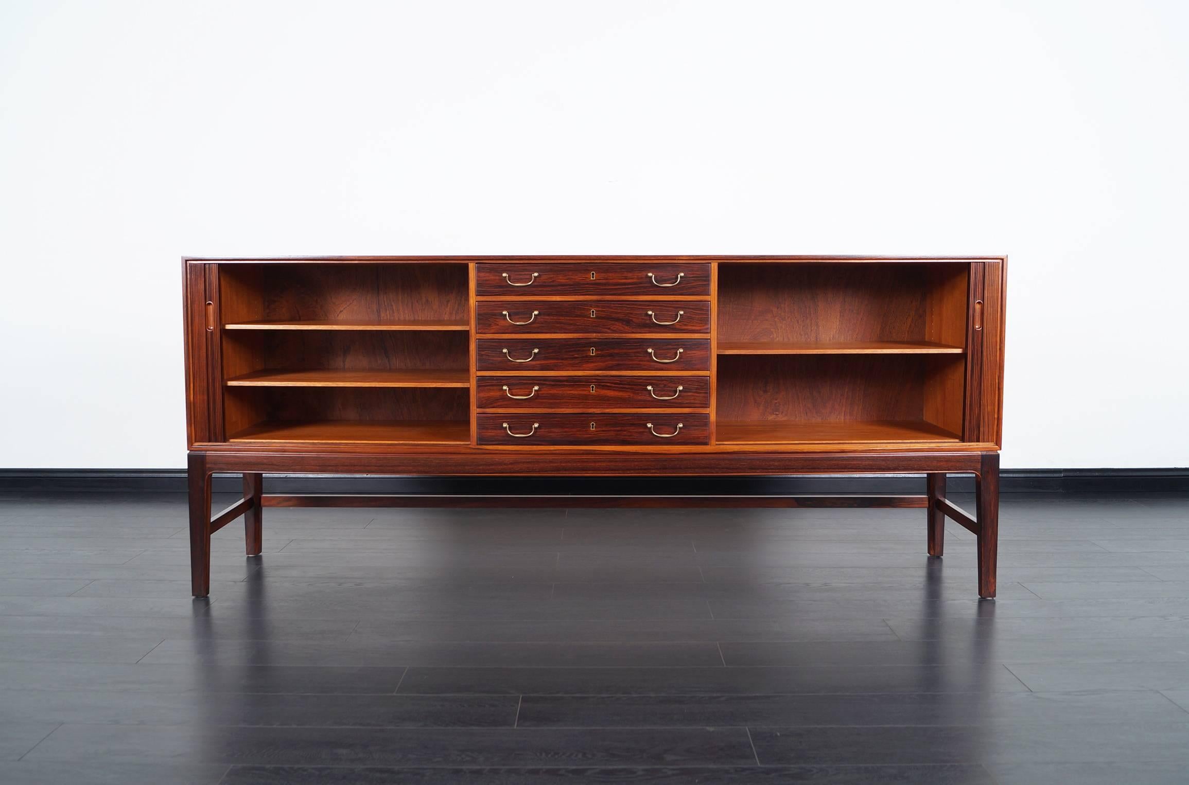 Stunning Danish Brazilian rosewood tambour doors credenza designed by Ole Wanscher for A.J. Iversen Snedkemester in Denmark, circa 1960s This beautiful credenza features two tambour doors with adjustable shelves and five pull-out dovetailed drawers