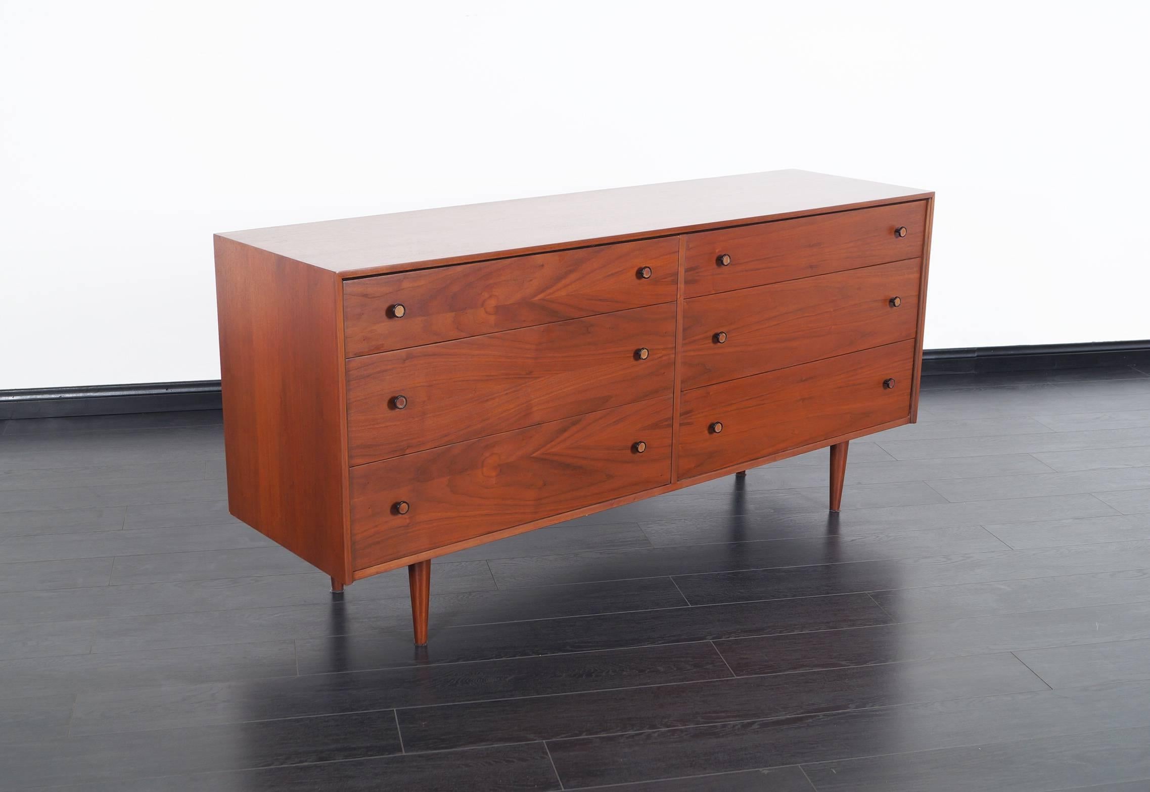 Mid-Century Modern walnut dresser. Features a total of six dovetail drawers.