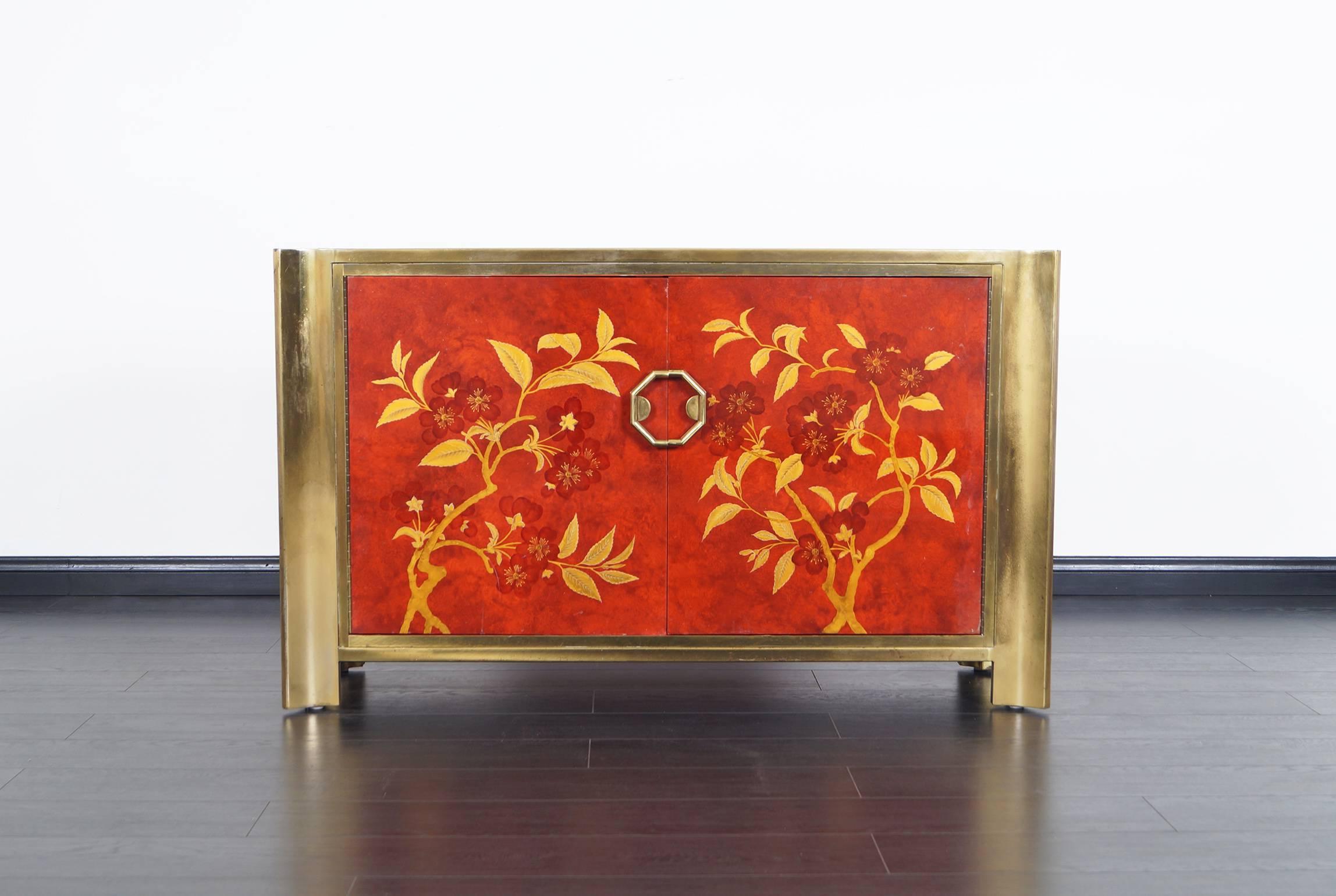Extremely rare red lacquered and brass credenza designed by Mastercraft. An exceptional piece in original vintage finish. It's just stunning from every angle.