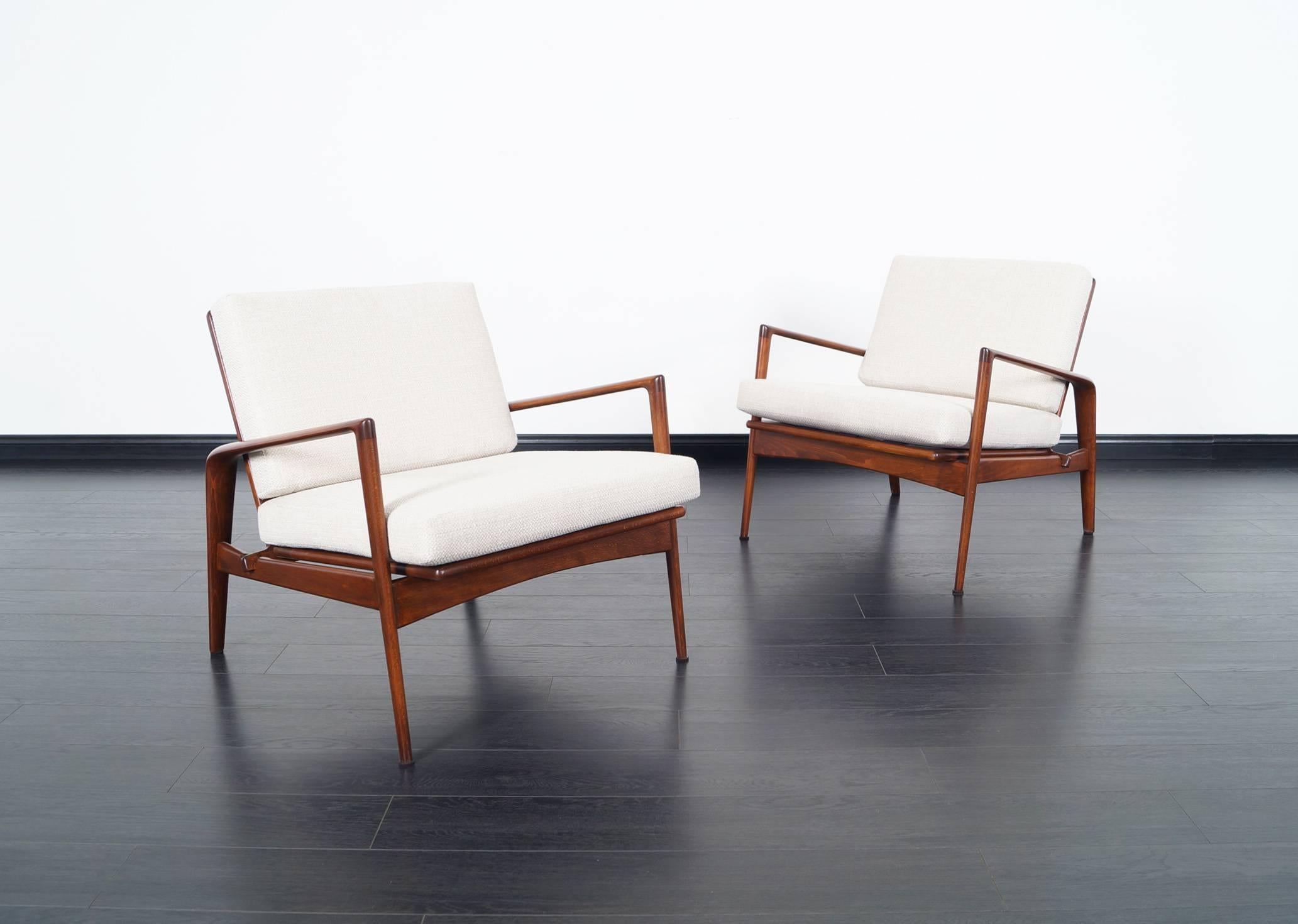 These fabulous rare Danish lounge chairs designed by Ib Kofod Larsen. Features sculptural design and great craftsmanship quality.