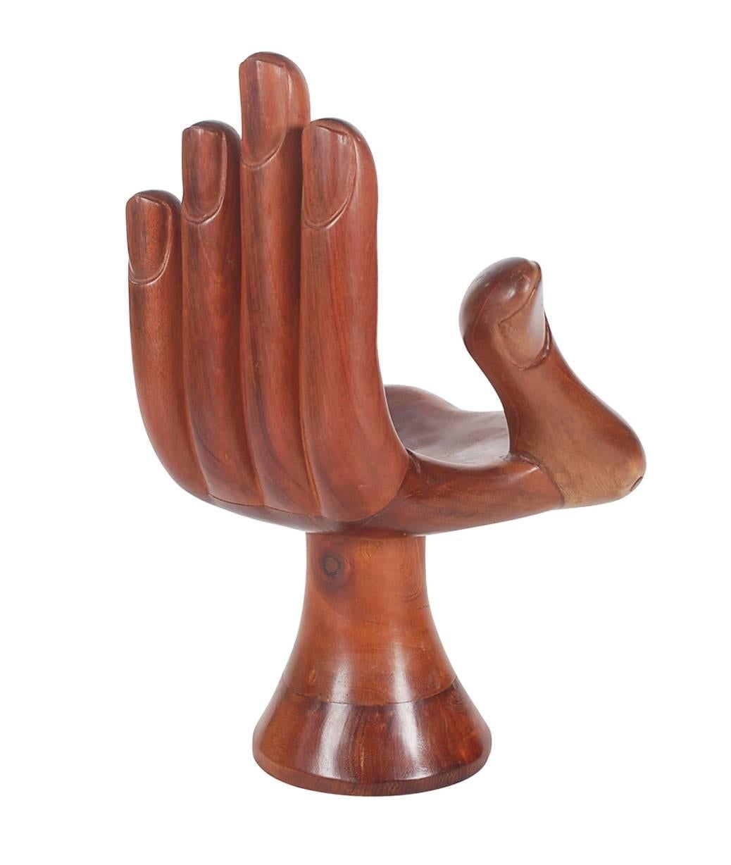 An iconic hand form sculpture after Pedro Friedeberg. It features solid mahogany construction. Unmarked.