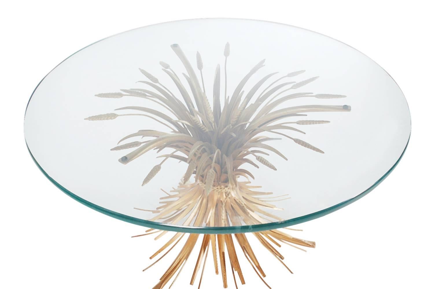 A very sharp looking sheaf of wheat coffee or cocktail table, made in Italy in the 1960s. It features a gold steel base with a thick glass top.