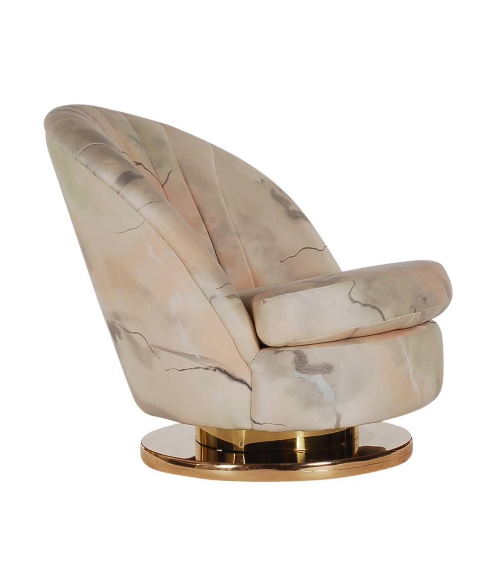 A classic and chic designed slipper chair by Milo Baughman for Thayer Coggin. It features a brass swivel and tilting base with original fabric. Very comfortable chair.