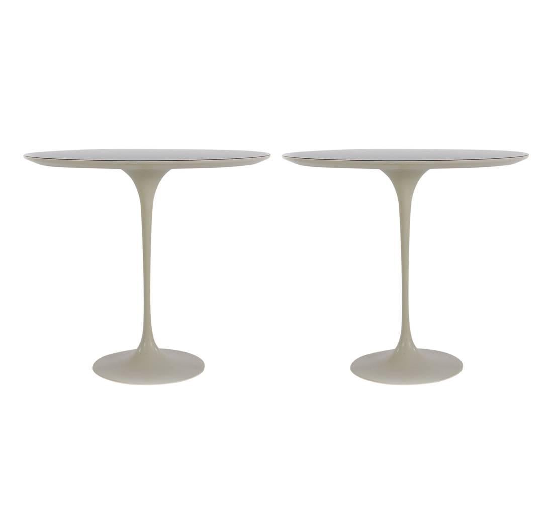 An early matching pair of Eero Saarinen for Knoll Tulip tables. These are oval side tables with while laminate tops. Incredibly well cared for through the years. Early cloth label to one.