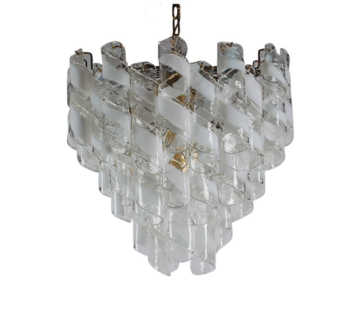 A stunning masterpiece after Mazzega for Murano glass chandelier. It features blown art glass prisms on a brass structure. It takes 13 candelabra bulbs. Tested and fully working. Ready for immediate use.
