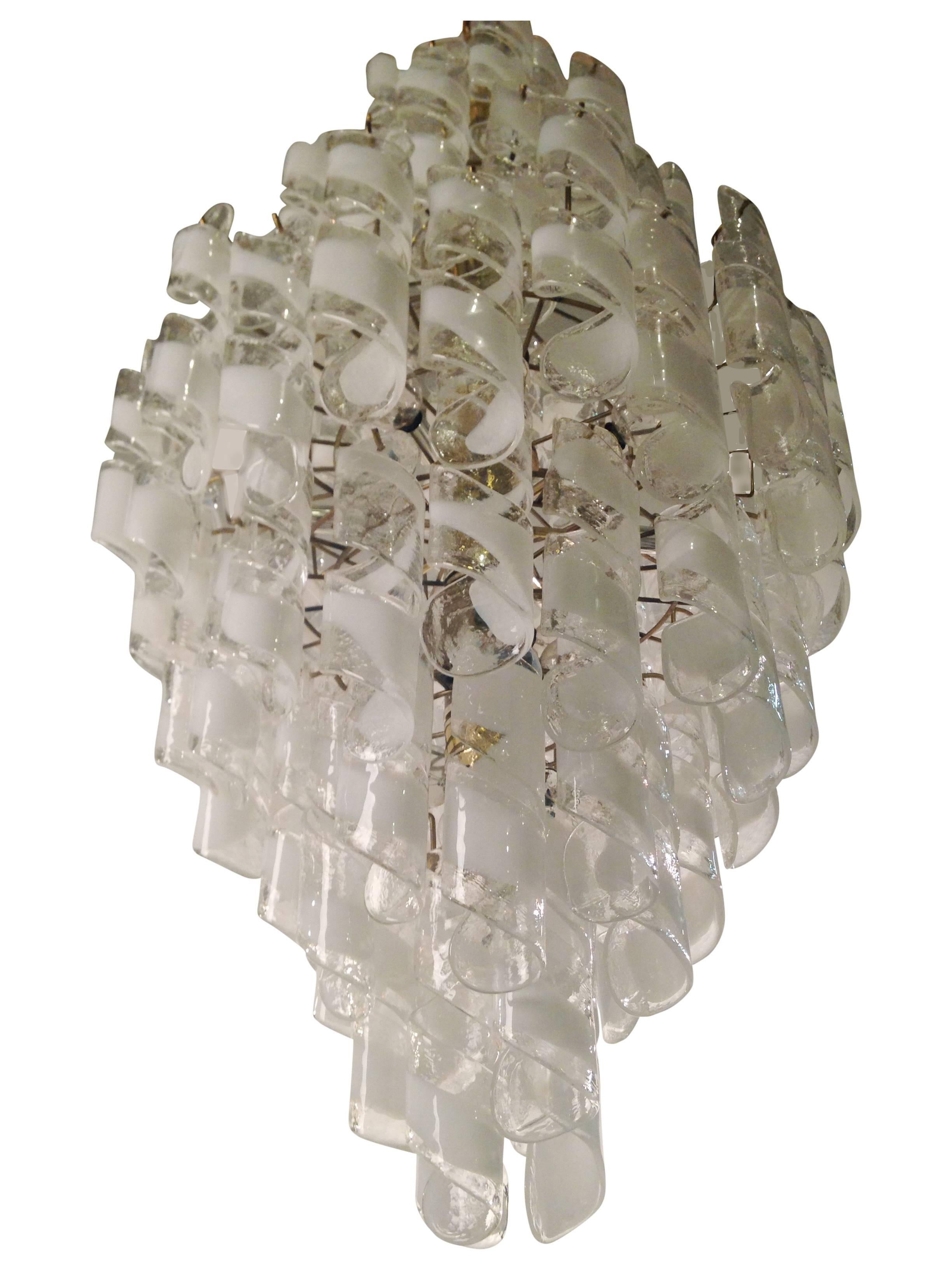 A huge and stunning masterpiece after Mazzega for Murano glass chandelier. It features blown art glass prisms on a brass structure. It takes 23 candelabra bulbs. Tested and fully working. Ready for immediate use.