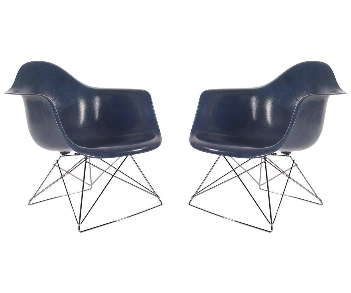 Here we have an iconic design Classic from the Mid-Century Modern period. This vintage fiberglass shell chair was designed by Charles Eames and produced by Herman Miller circa 1972. Very hard to find Navy Blue color. The chair seats are vintage, and