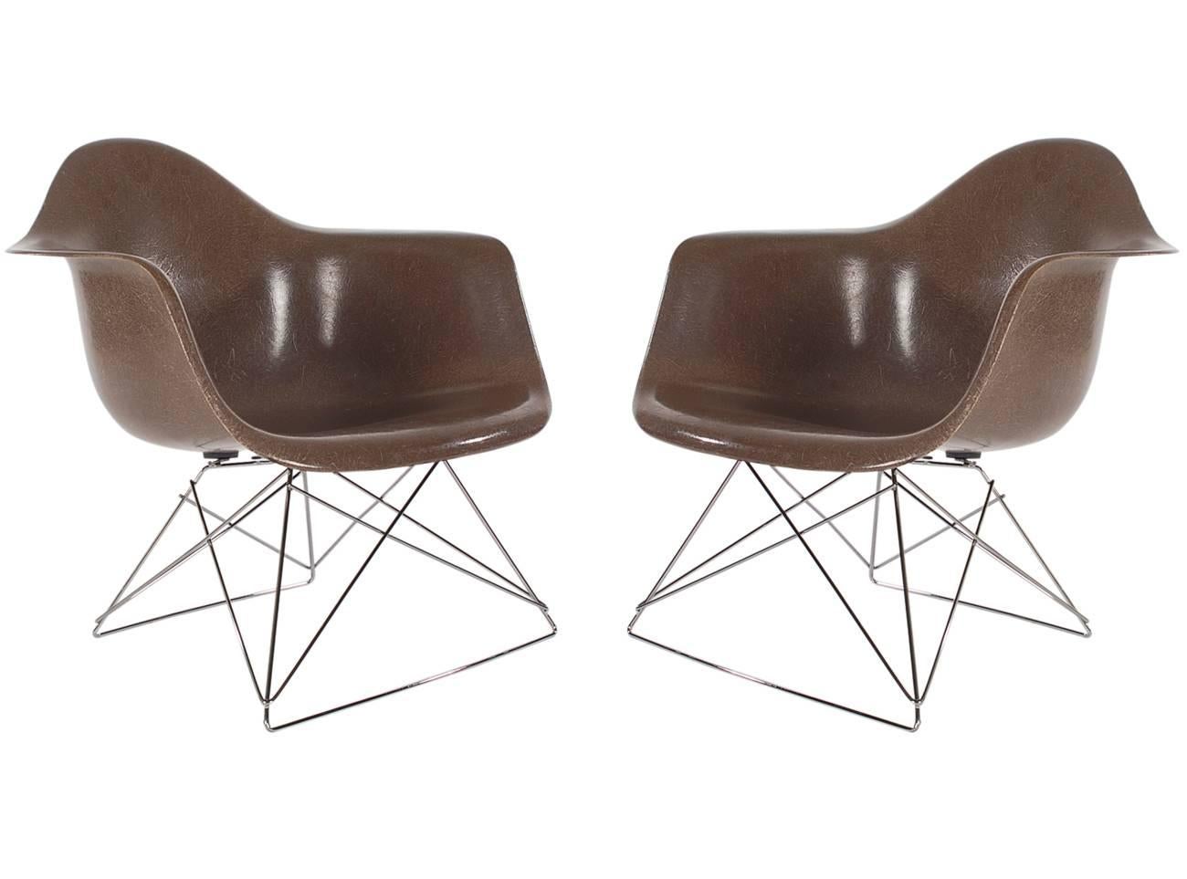 Here we have an iconic design Classic from the Mid-Century Modern period. This vintage fiberglass shell chair was designed by Charles Eames and produced by Herman Miller, circa 1972. In a very hard to find color, chocolate brown. The chair seats are