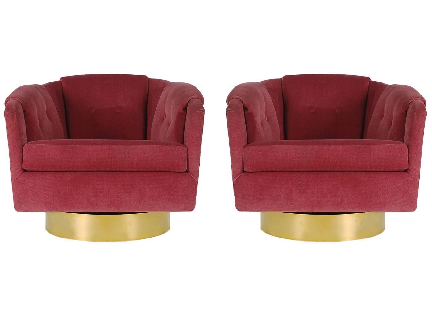 A stately matching pair of brass base swivel club chairs in the manner of Harvey Probber or Milo Baughman. They feature the original velvet upholstery with 360 degree swiveling bases. 

In the style of: Milo Baughman or Harvey Probber.