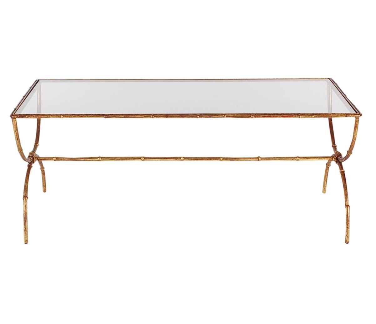 A very handsome thin framed Hollywood Regency coffee table from Italy in the 1960s. It features a gold gilded faux bamboo frame with inlaid clear glass. Very clean and ready for immediate use.
