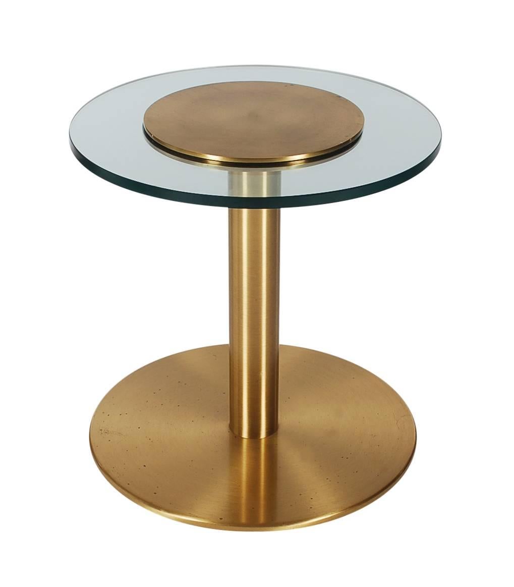 Extremely heavy well made table. It features heavy brass pedestal frame with thick glass top. Marked: made in Canada, circa 1980-1990s.

In the style of: Karl Springer, Leon Rosen, Pace Collection, Cedric Hartman.
