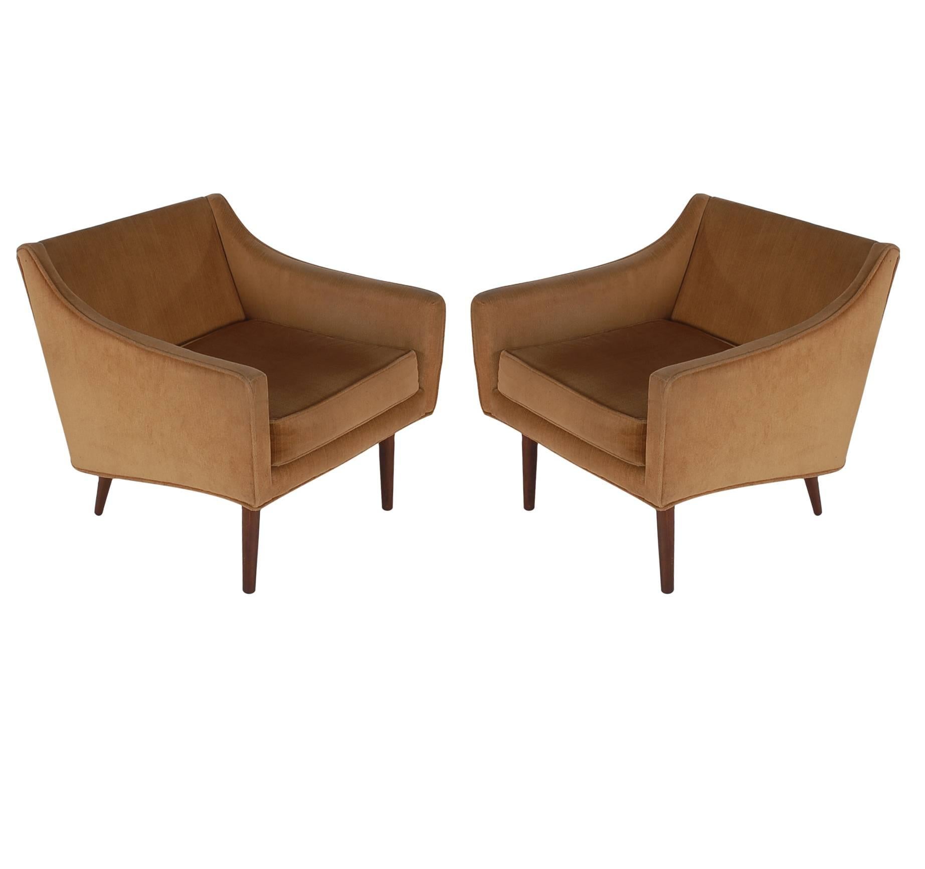 A handsome matching pair of lounge chairs, circa 1960s. The have absolutely stunning design lines with walnut legs. Fabric is original and has moderate wear, new upholstery is recommended.

In the style of: Milo Baughman, Paul McCobb, Edward