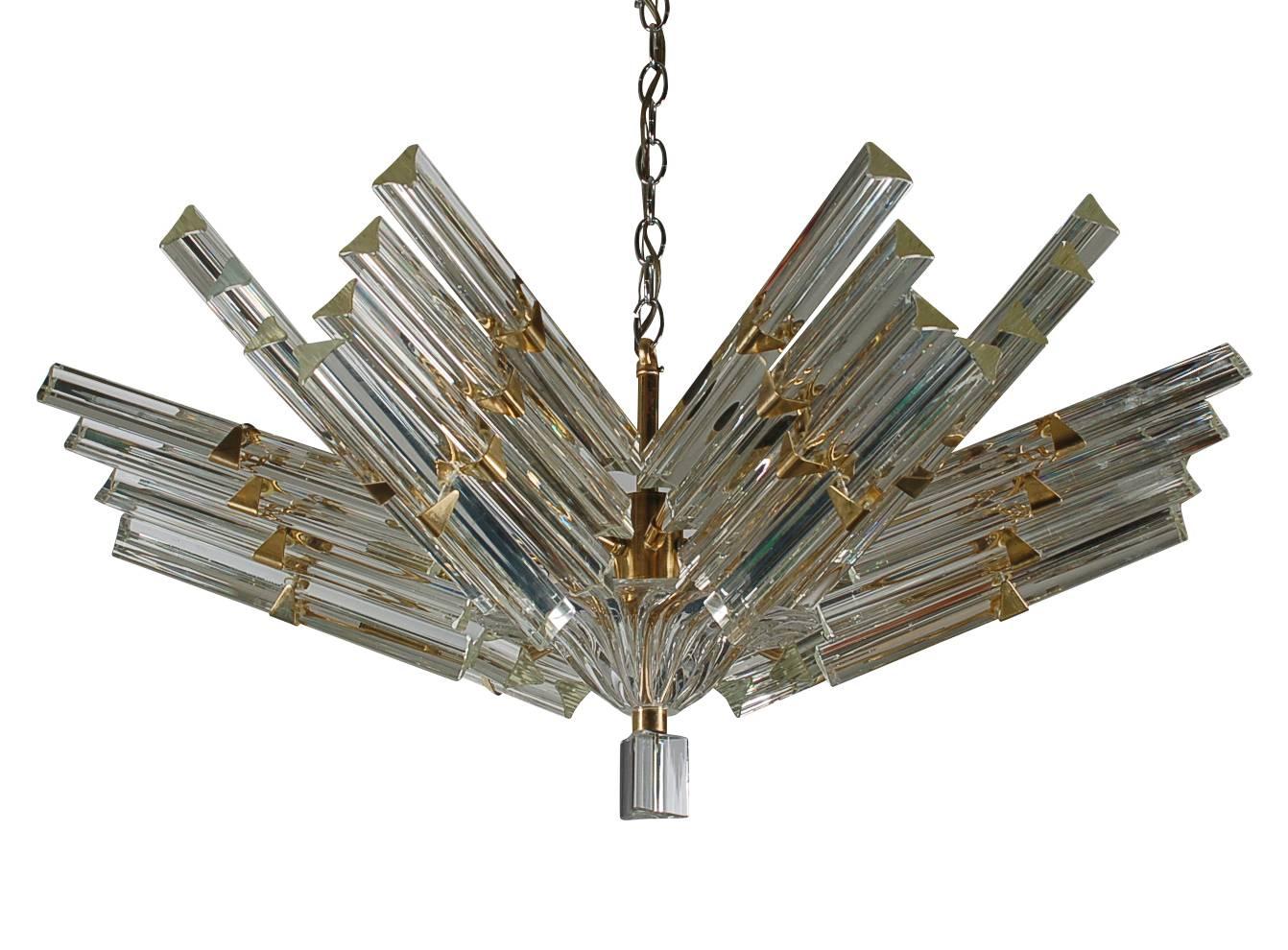 A large high quality glass and brass chandelier produced in Italy for Camer. It features a heavy brass frame with Venini Tiedri glass prisms. It takes six standard bulbs and a brass ceiling finishing plate is included and not shown.