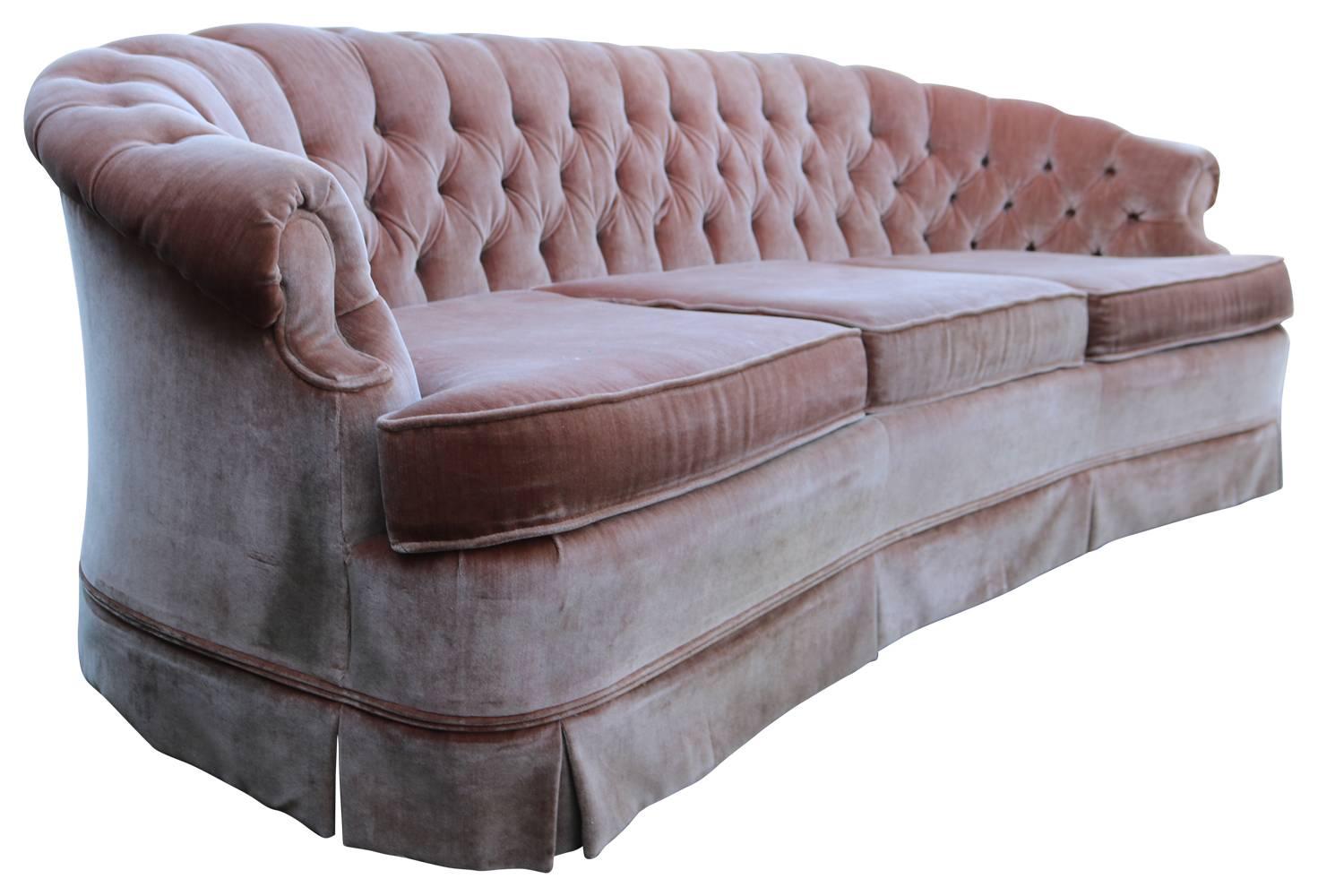 Gorgeous dusty rose pink vintage sofa with gently curved back and tufted detail. Fabric does show wear and some staining. A steam cleaning may alleviate most, but perfectionists will wish to reupholster.