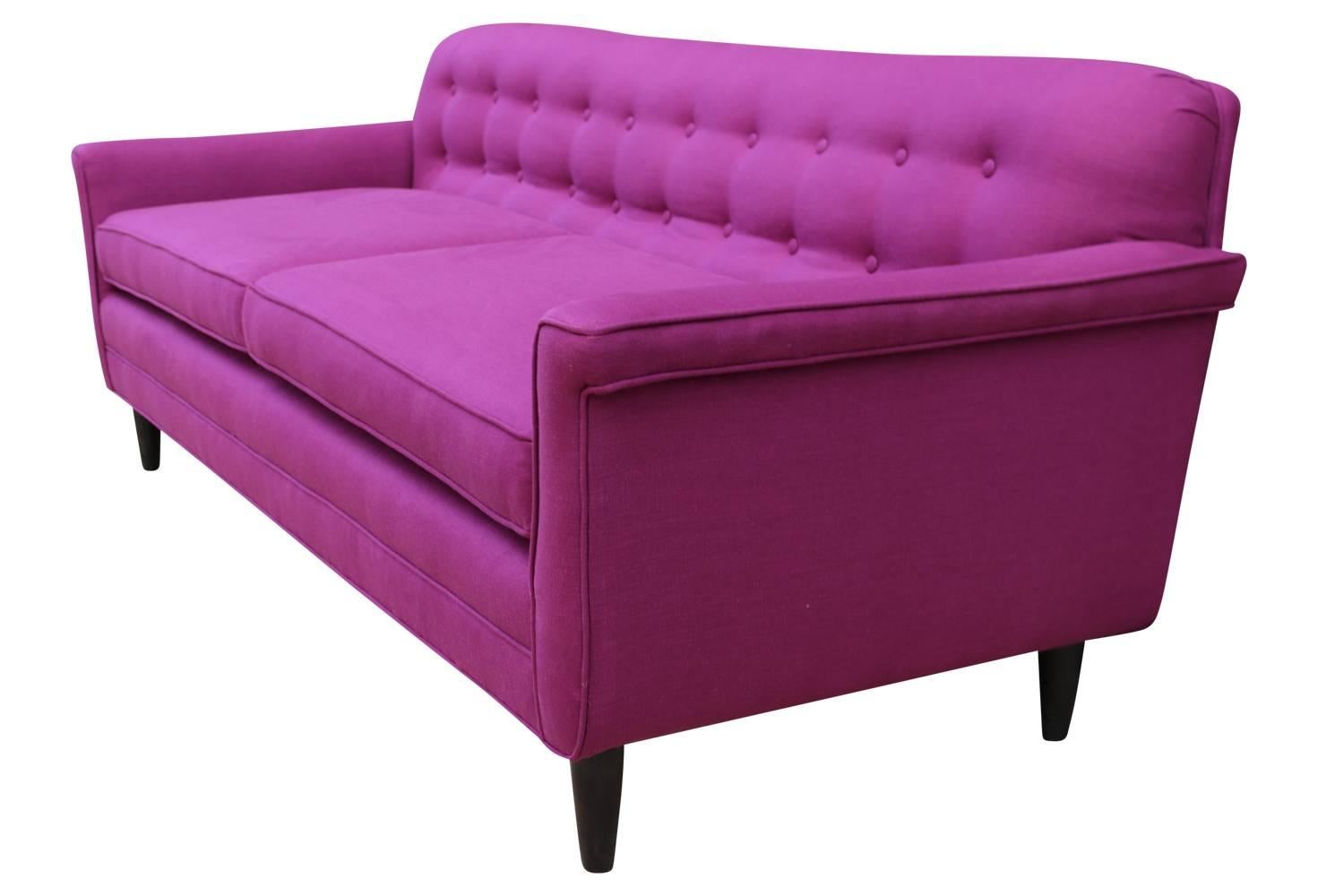 This is a rare example of Wormey's work, a variation on his "Career Group" line. Sofa has been lovingly restored with new foam and clothed in a lovely raspberry pink linen. All original details have been maintained.