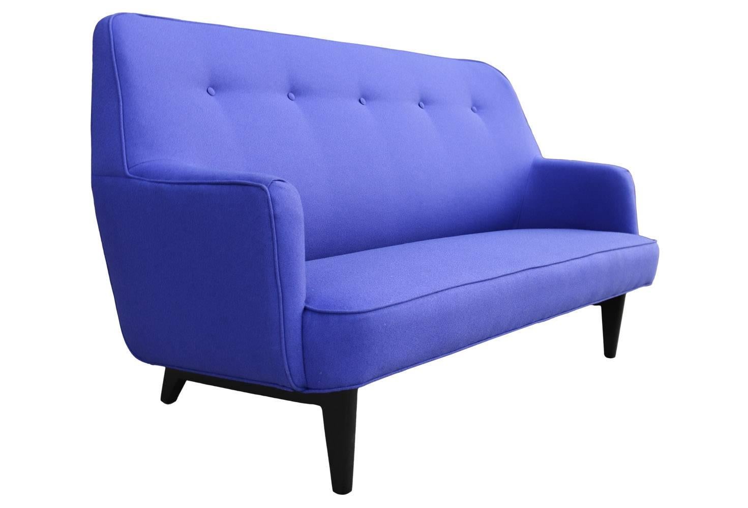 Its an amazing color, hard to put your finger on! Is it blue? Or purple? Either way, it is sure to make you smile! This vintage Mid-Century Modern sofa has been lovingly restored, new fabric and a fresh coat of black stain on the legs. It's perfect.