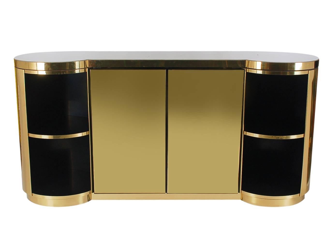 A stunning masterpiece that will add elegance to any space. This cabinet or sideboard is extremely heavy and well made. It features a real brass exterior, a pearl colored epoxy top, and black laminate interiors with plenty of storage space. 

In