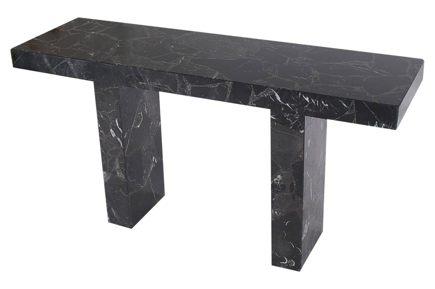 A stunning and simple modern console table in the style of Karl Springer. It consists of heavy black solid marble. Beautiful veining in marble, probably Italian.