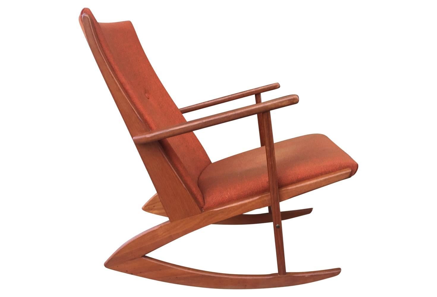 This iconic Mid-Century rocking chair is in great condition with its original orange tweed upholstery. Light fading to seat fabric, but presents beautifully!