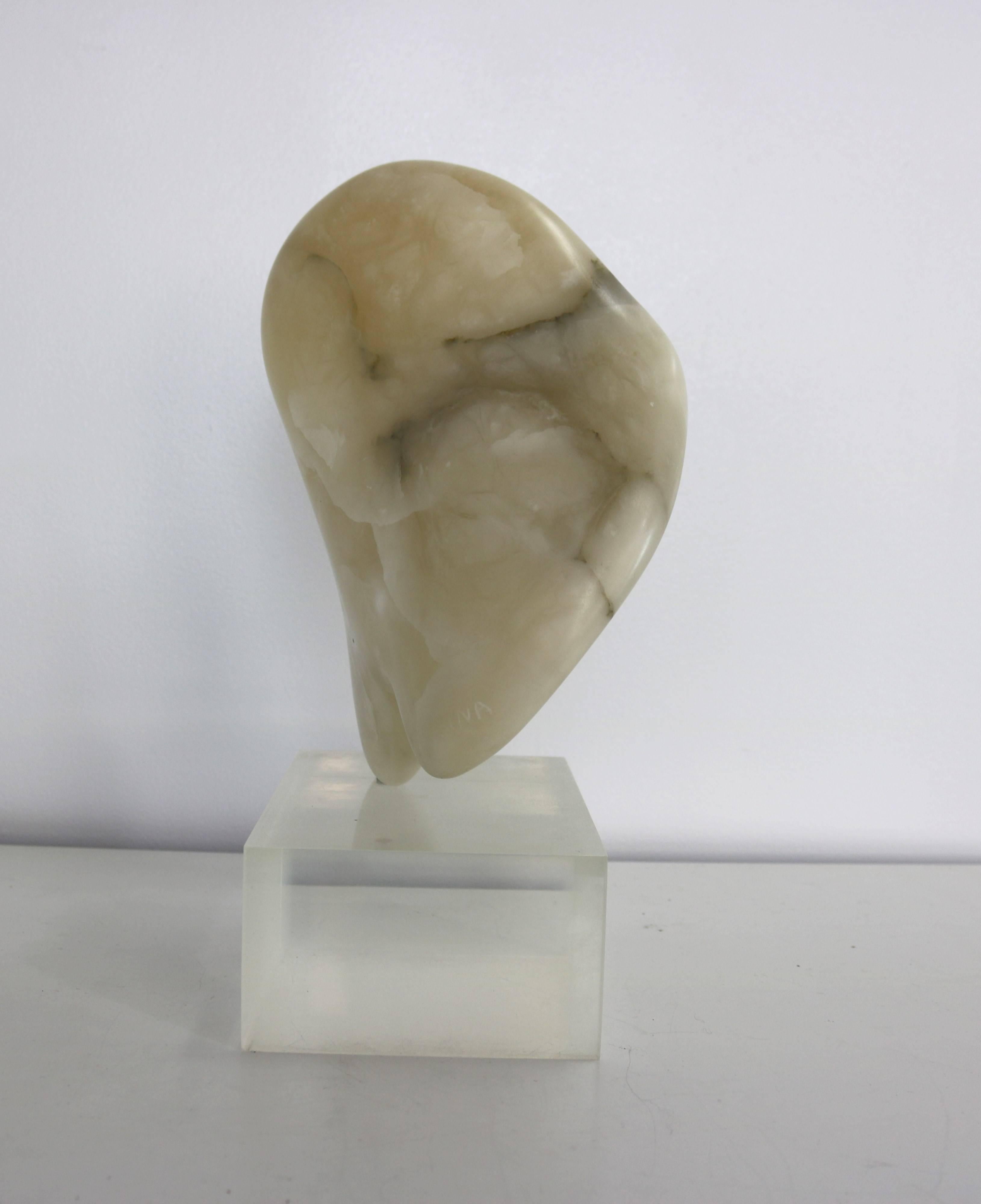 Reminiscent of the work of Jean Art, this lovely biomorphic sculpture is perches atop a Lucite base. Signed.